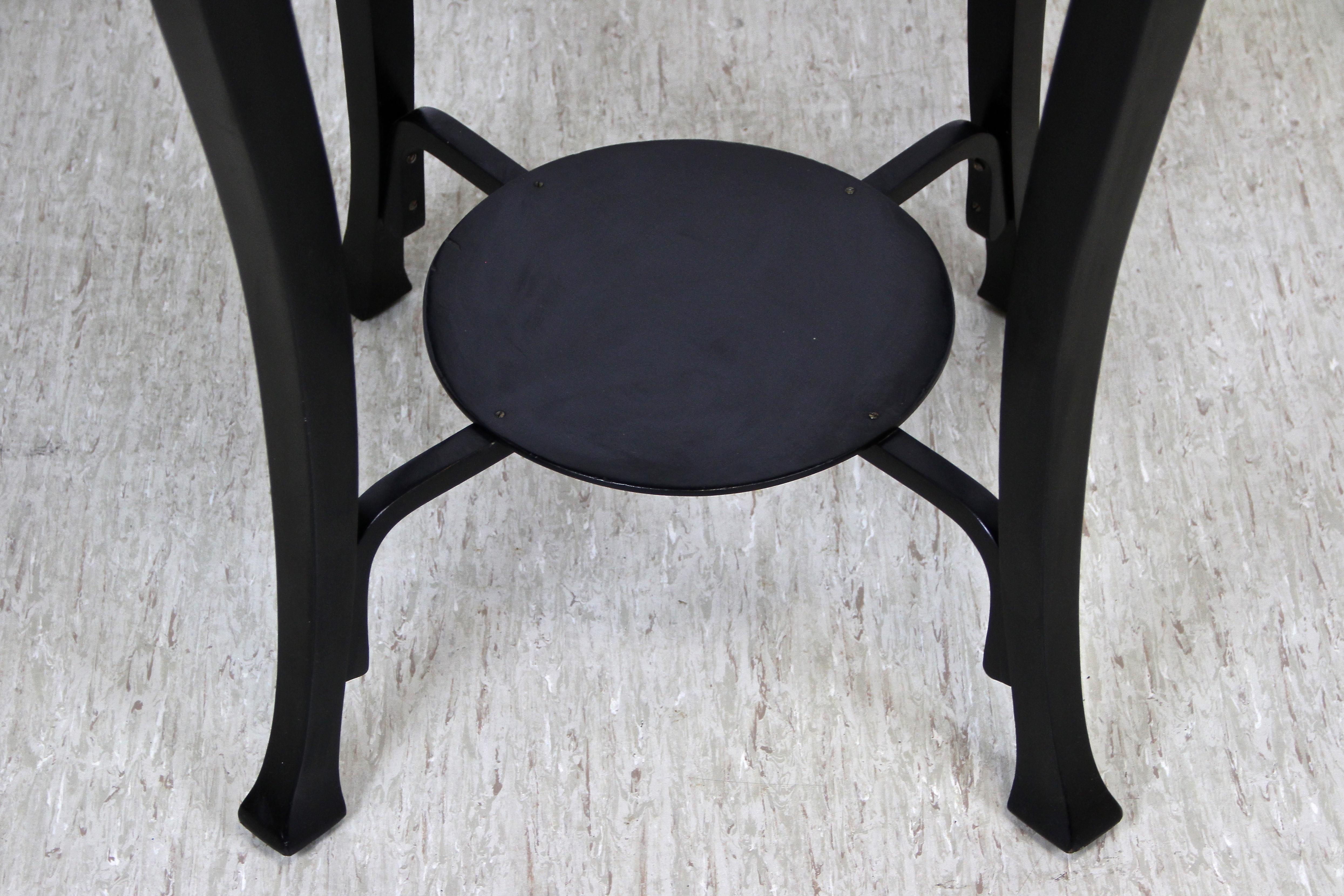 Impressive black Art Nouveau coffee or side table made by the world renown bentwood specialists Jacob & Josef Kohn in Vienna/ Austria, circa 1910. A stunning shape with round tabletop and beautifully curved legs, all artfully connected by an