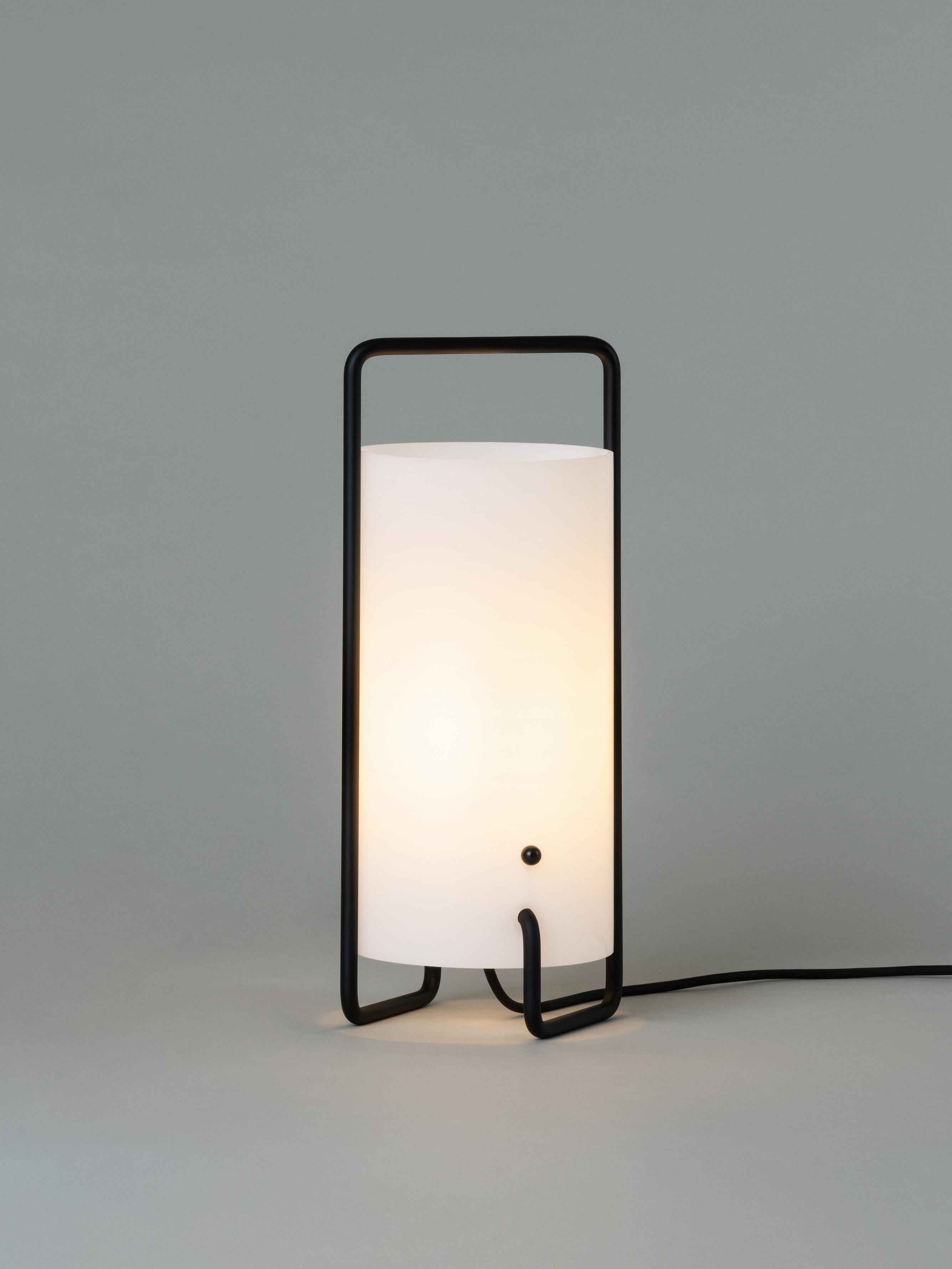 Black Asa table lamp by Miguel Milá
Dimensions: D 15 x H 41 cm
Materials: Metal, methacrylate shade.

Asa is built of an ingenious, single, continuous tube structure which also defines the upper, handle-shaped structure for carrying. It has two