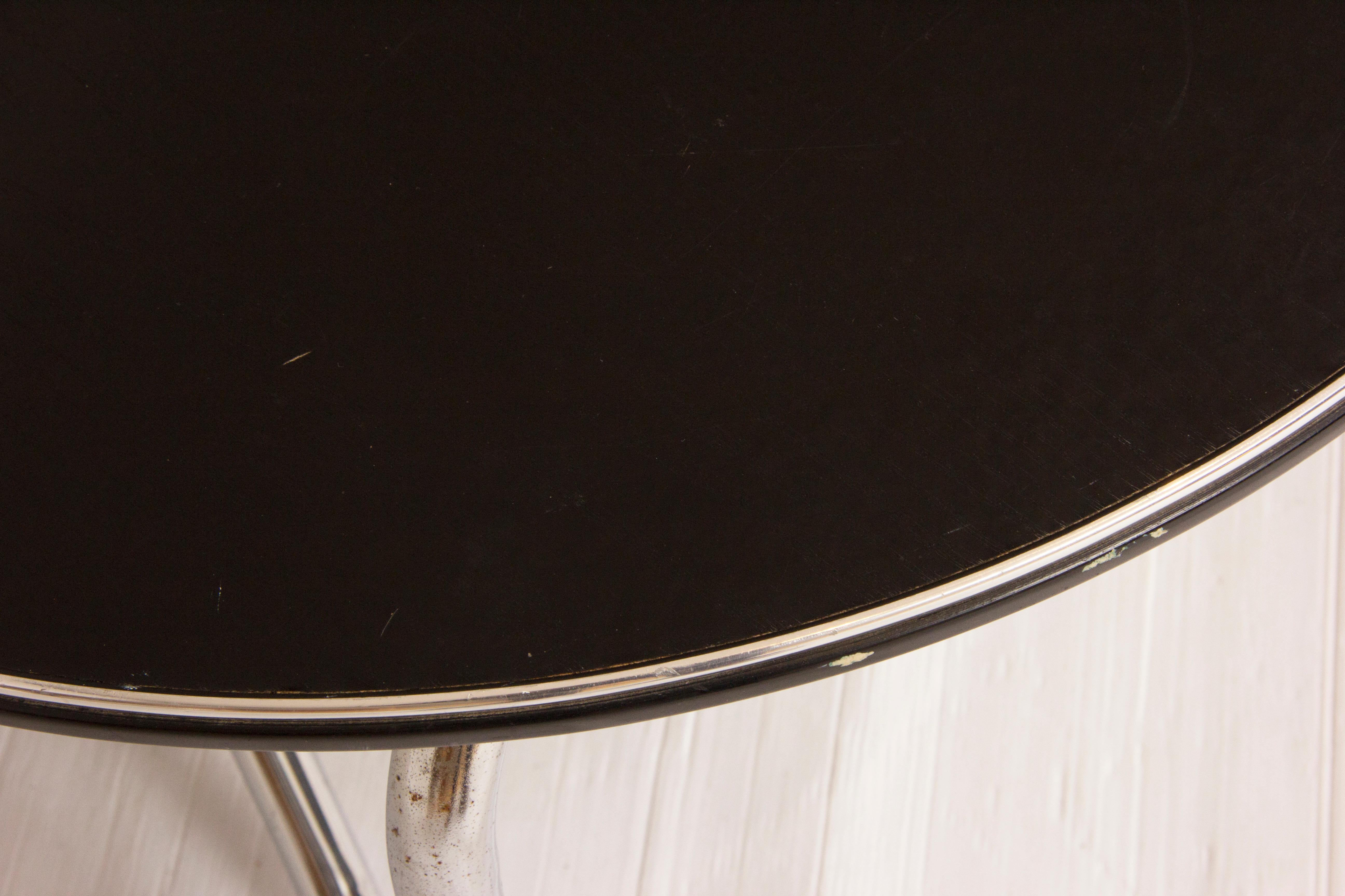Black ash and tubular chrome coffee table,
British, circa 1960.
Measures: H 38cm, W 61cm, D 61cm.