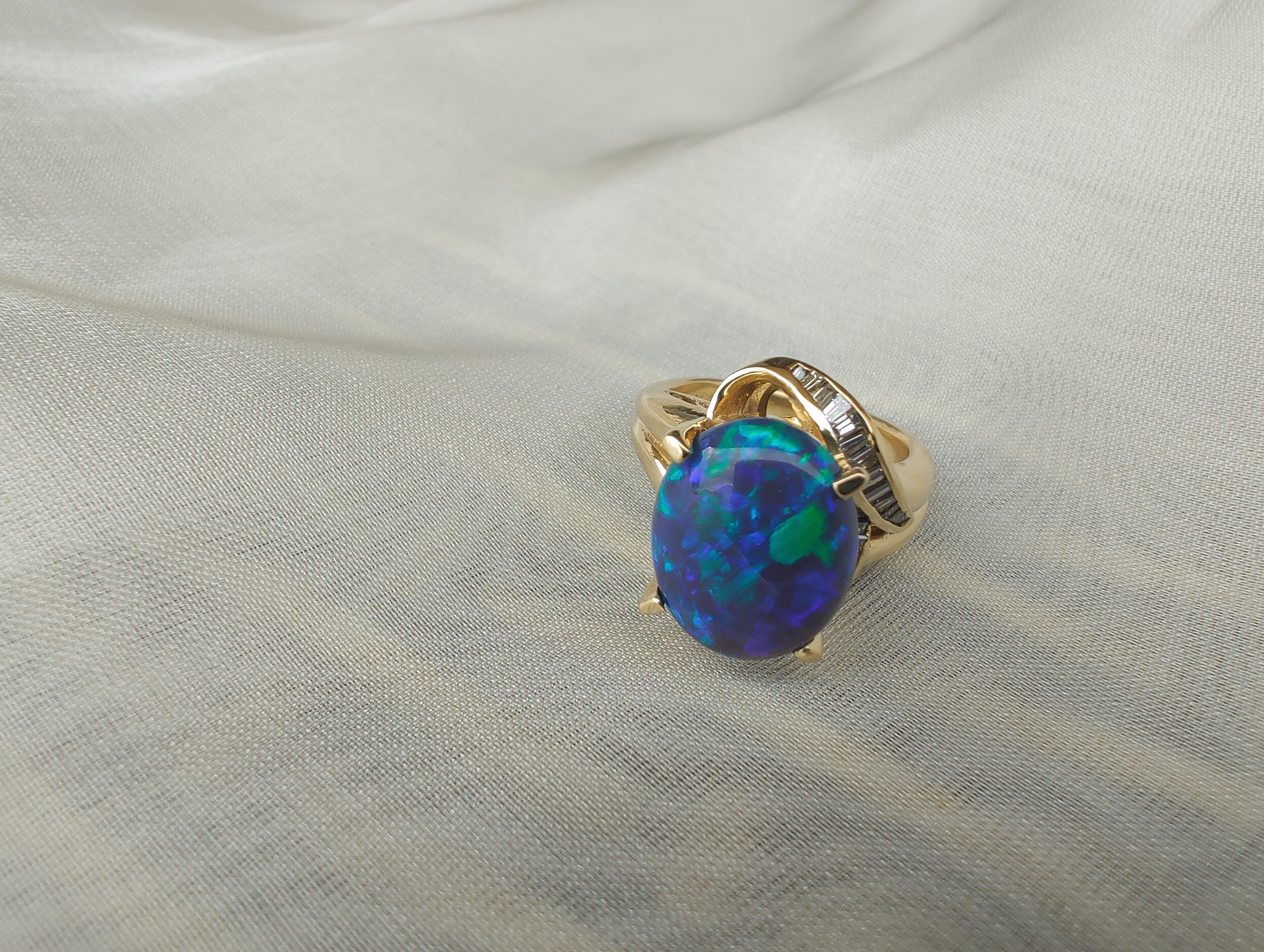 Australian gem quality solid black Opal (10.8x13.1mm) and tapered baguette diamond ring set in 18ct yellow gold.
Black opal is often called the “king of opals”. It was discovered in 1902 in Lightning Ridge, New South Wales, Australia.
Black opal is