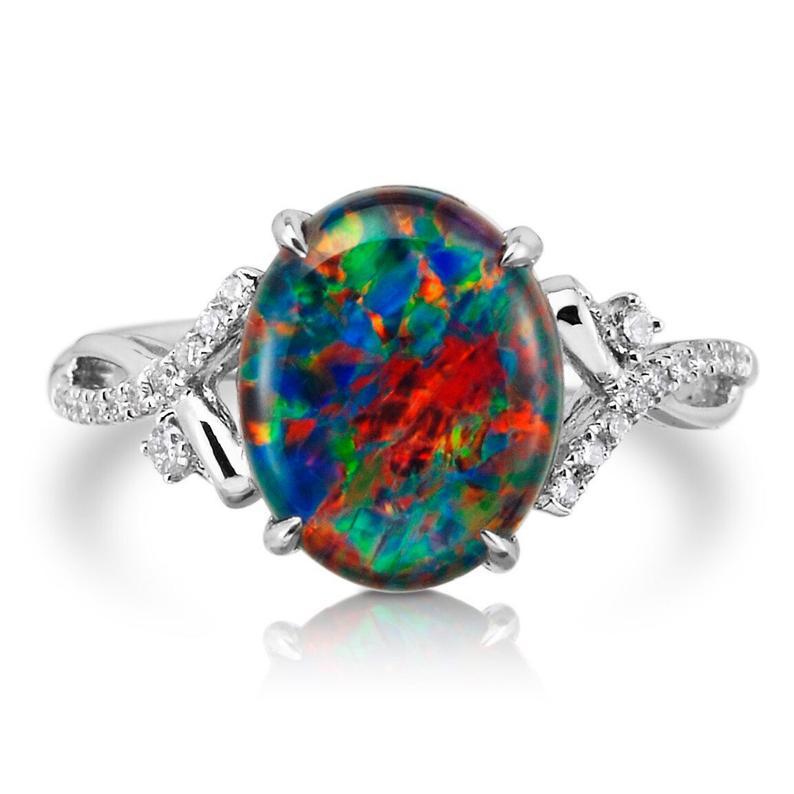 
This is a unique Australian Opal ring shows off bright colors  Green Blue Red Orange  and these are very rare due to the fact they are so hard to find. With 24 Diamonds it really does stand and set in 18 Karat White Gold . Its in this Art Deco