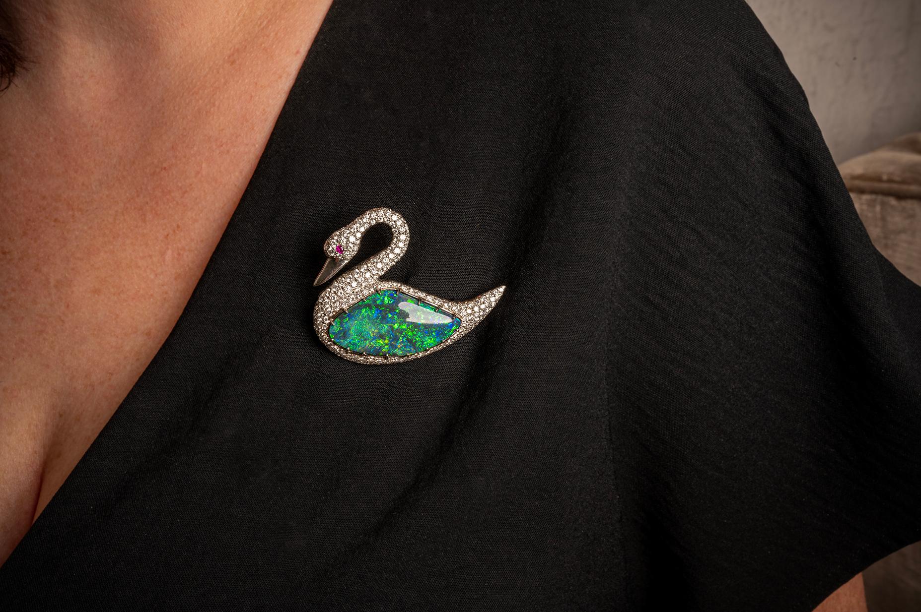 Black Australian Opal & Diamond Swan Brooch/Pendant in Platinum. The swan features a 21.83ct Black Australian Opal and 2.50ctw of round diamonds. The swan can be worn as a brooch or pendant. 
Dimensions 2.25