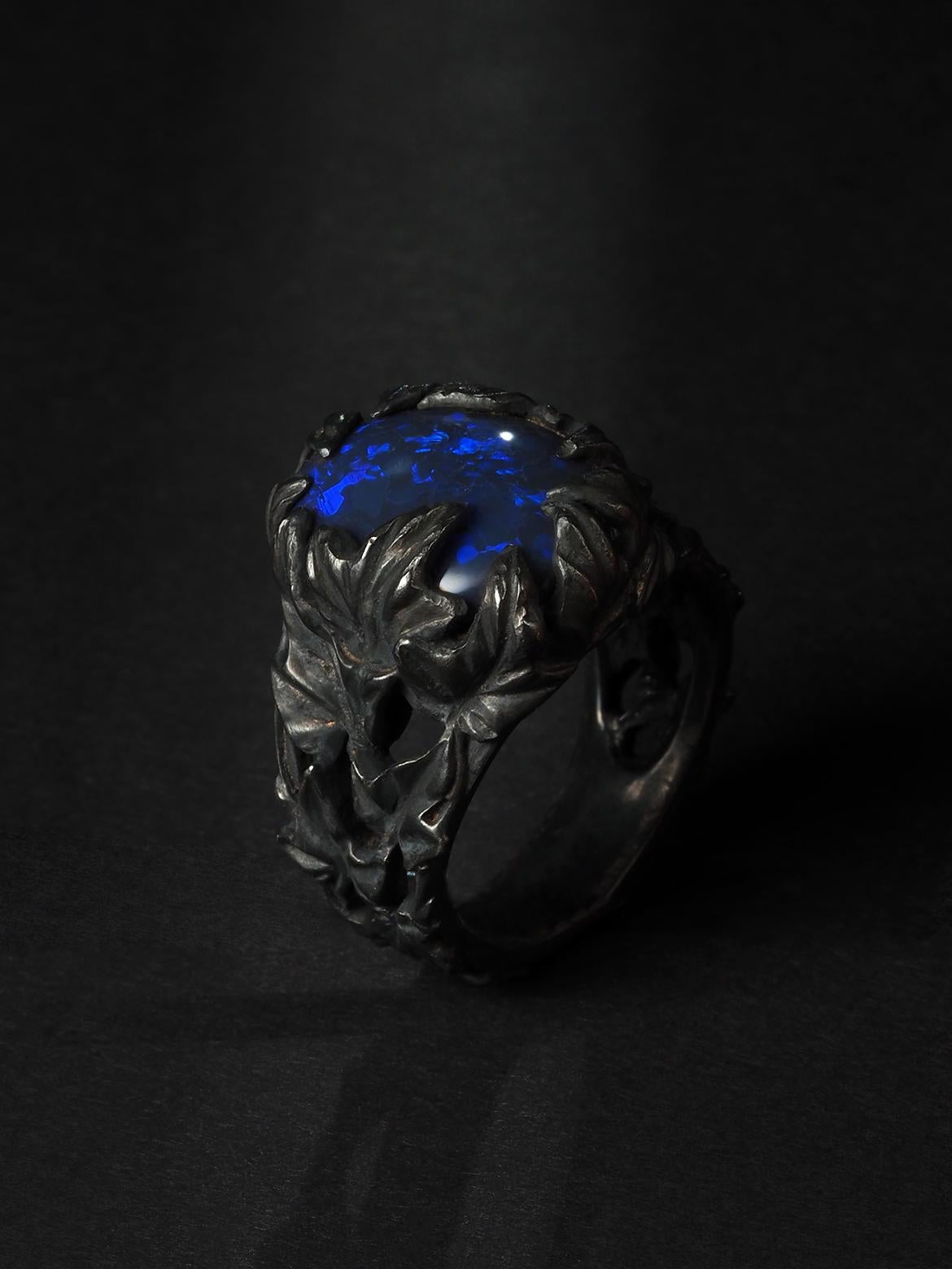 Introducing the mesmerizing Magic Natural Black Opal Ivy ring, a true symbol of opulence and sophistication. This exquisite piece showcases a captivating black opal sourced all the way from Australia, a land known for its remarkable opal
