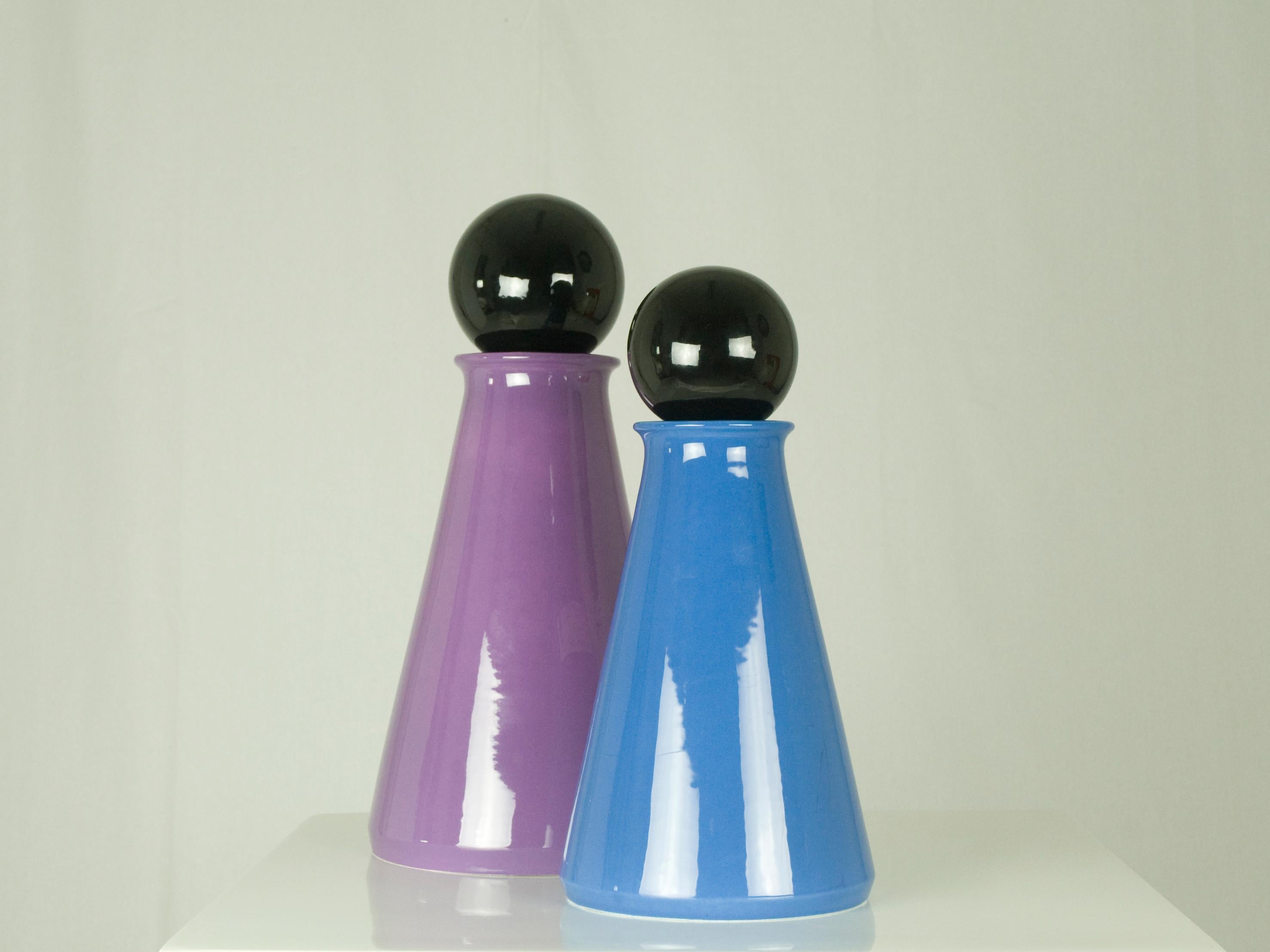 Pair of decorative bottles made from blue, violet and black ceramic.
Measures: Big bottle cm 43 H x 21 D.
Medium bottle cm 36 H x 18 D.

   