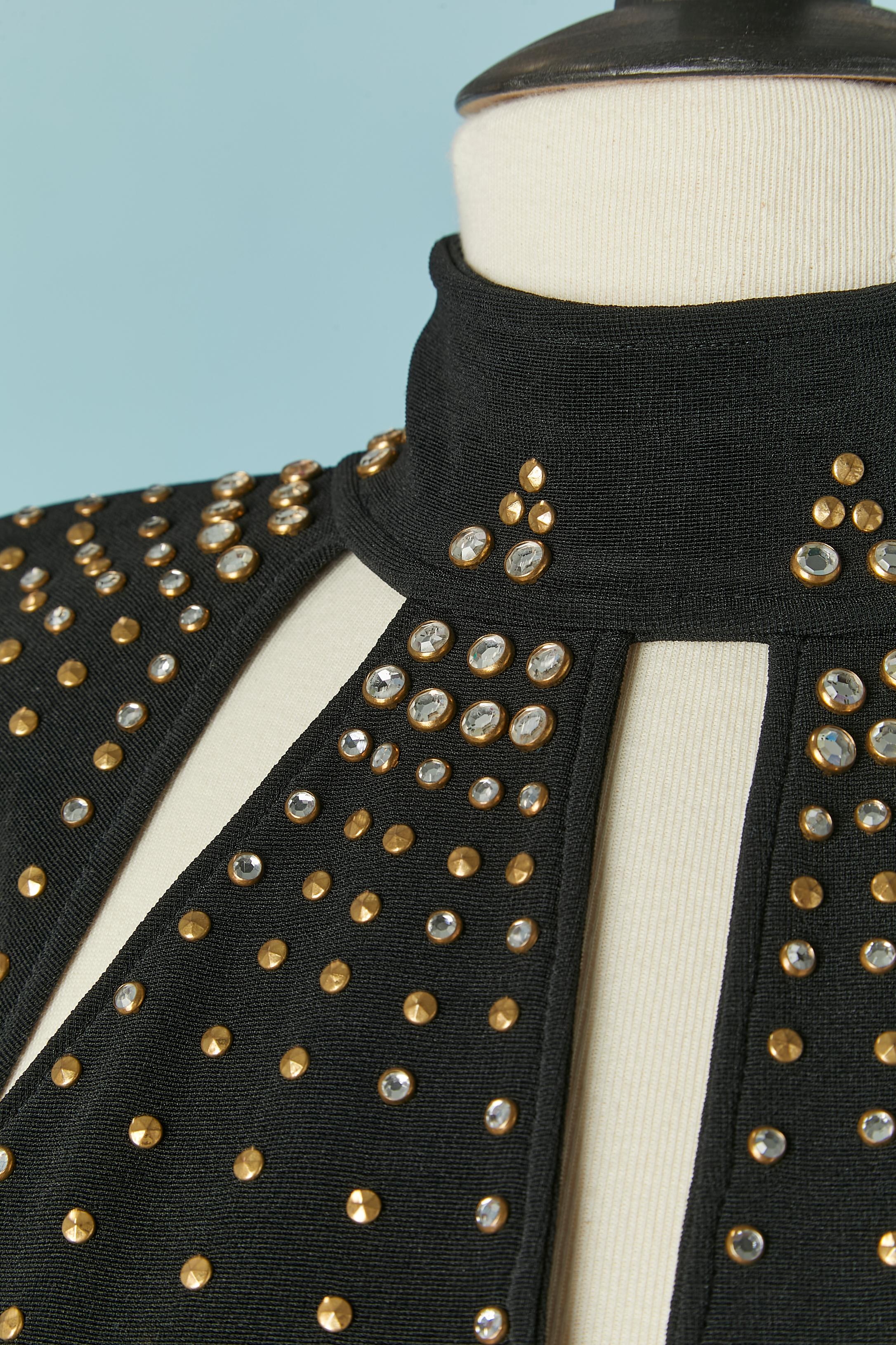 Black  backless jumpsuit with stud and rhinestone.
Main fabric composition: polyester and lycra 
Zip closure on the middle back + hook&eye. Shoulder pad. Elastic band under the feet. 
SIZE M