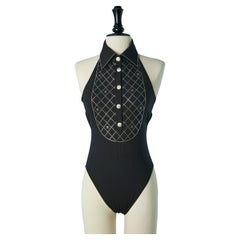 Black backless swimsuit with rhinestone plastron and button Chanel Resort 2023
