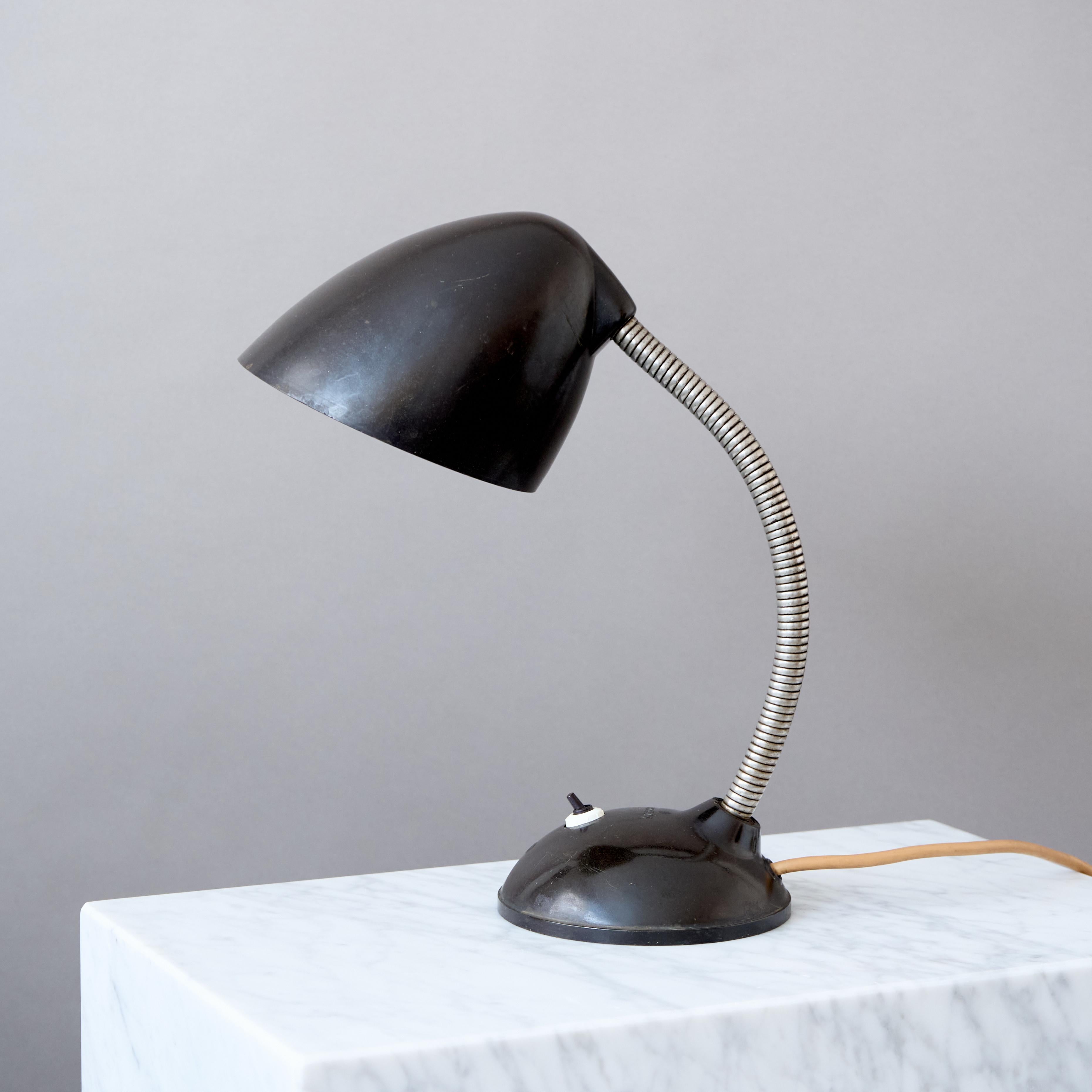 The design of this bakelite table lamp comes from Great Britain. This gooseneck lamps were designed By Eric Kirkman Cole for the Czech republic market.
The production was then provided by the company Elektrosvit in the territory of the former