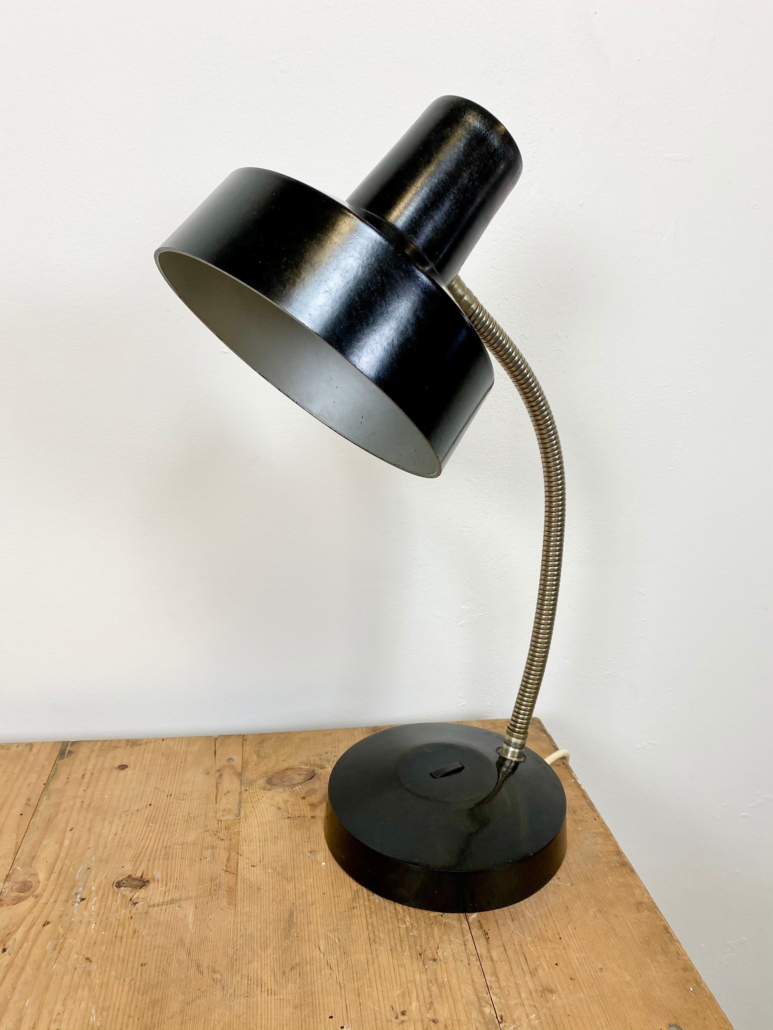 Vintage industrial bakelite adjustable desk lamp made by Elektrosvit in former Czechoslovakia during the 1960s. It features a black bakelite shade and base and a chrome plated gooseneck arm. The original socket requires E 27 lightbulb. The lampshade