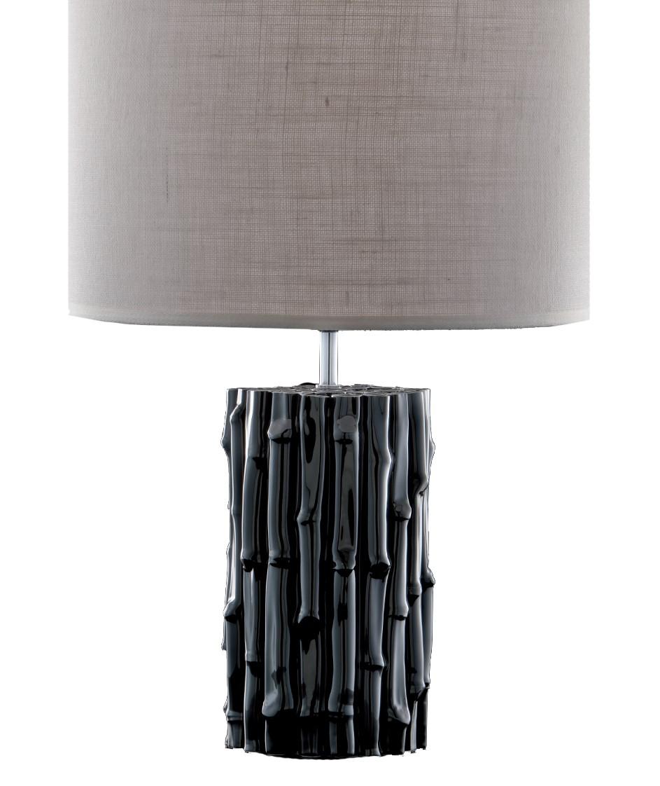 The body of this entirely handcrafted ceramic lamp resembles an arrangement of bamboo shoots. The exquisite details of the bamboo were rendered to perfection. Their opaque black coloration makes this lamp perfect for any decor. The white shade