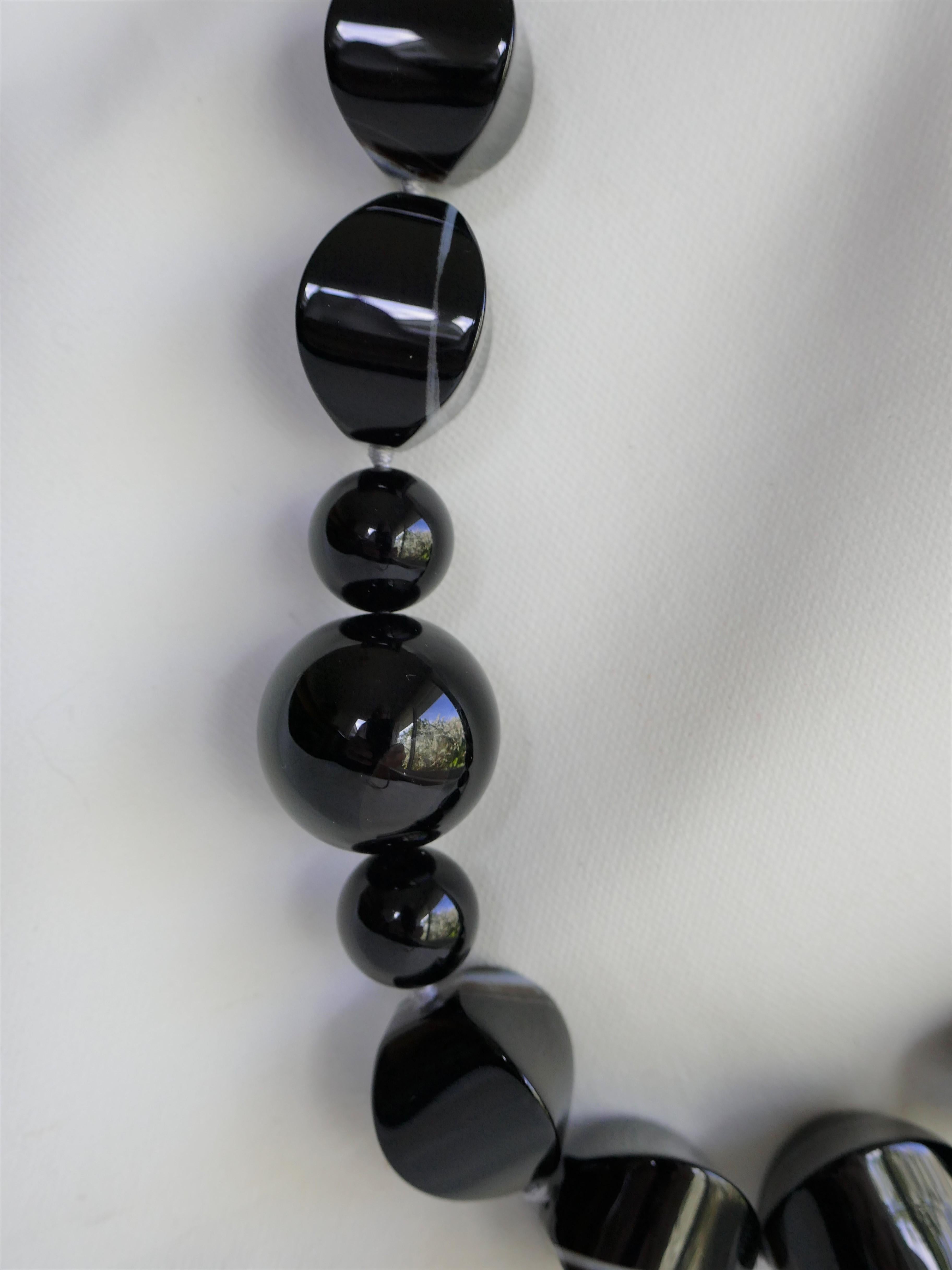 This necklace combines banded agate with 4 sizes of black onyx 12, 14. 20 & 22mm. The play with the shapes makes the necklace quite interesting. The necklace is very neutral and easy to wear. It is a classic, modern and a statement necklace.  It is