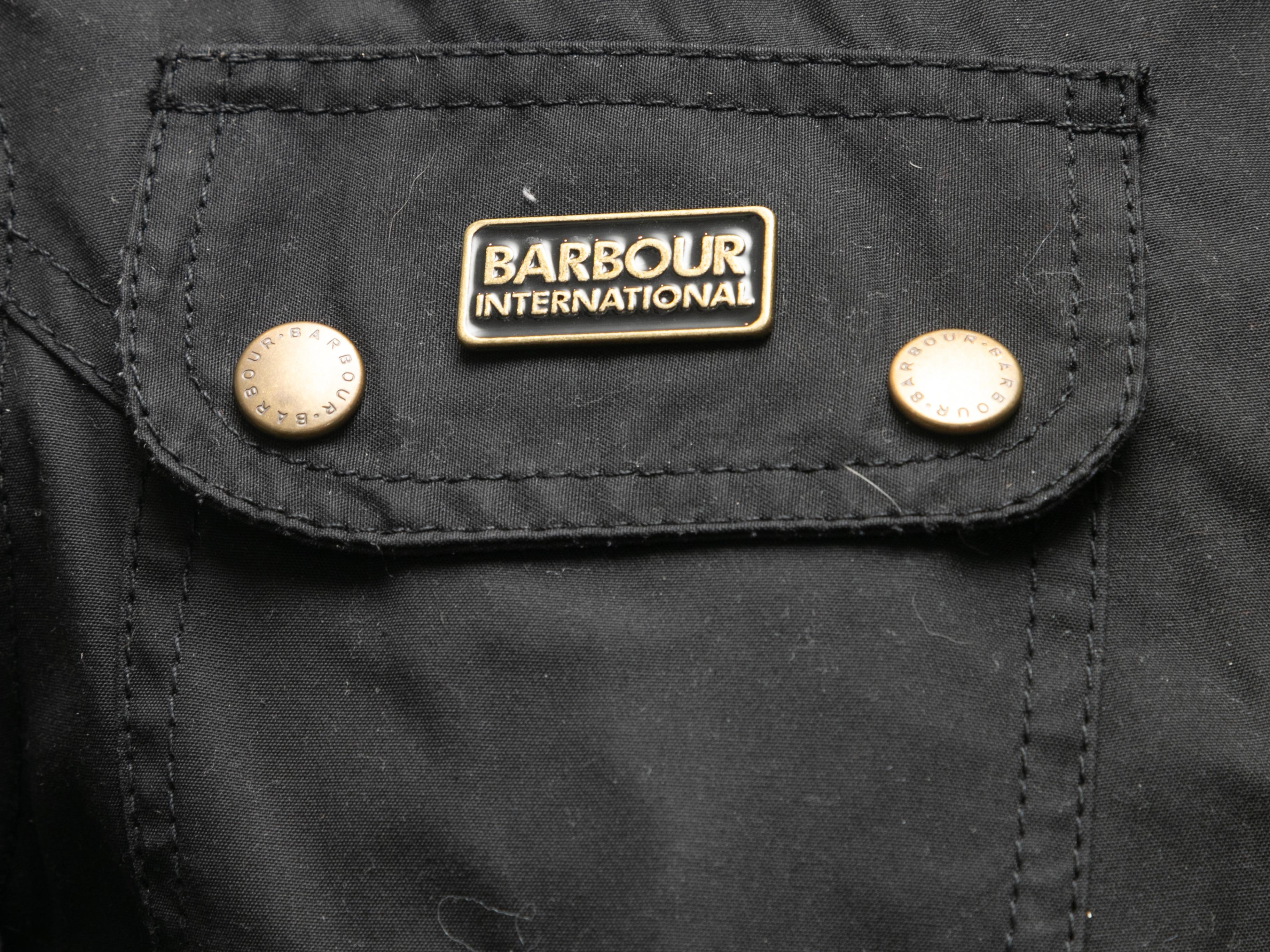 Black lined belted jacket by Barbour. Stand collar. Three pockets. Snap front closures. 36