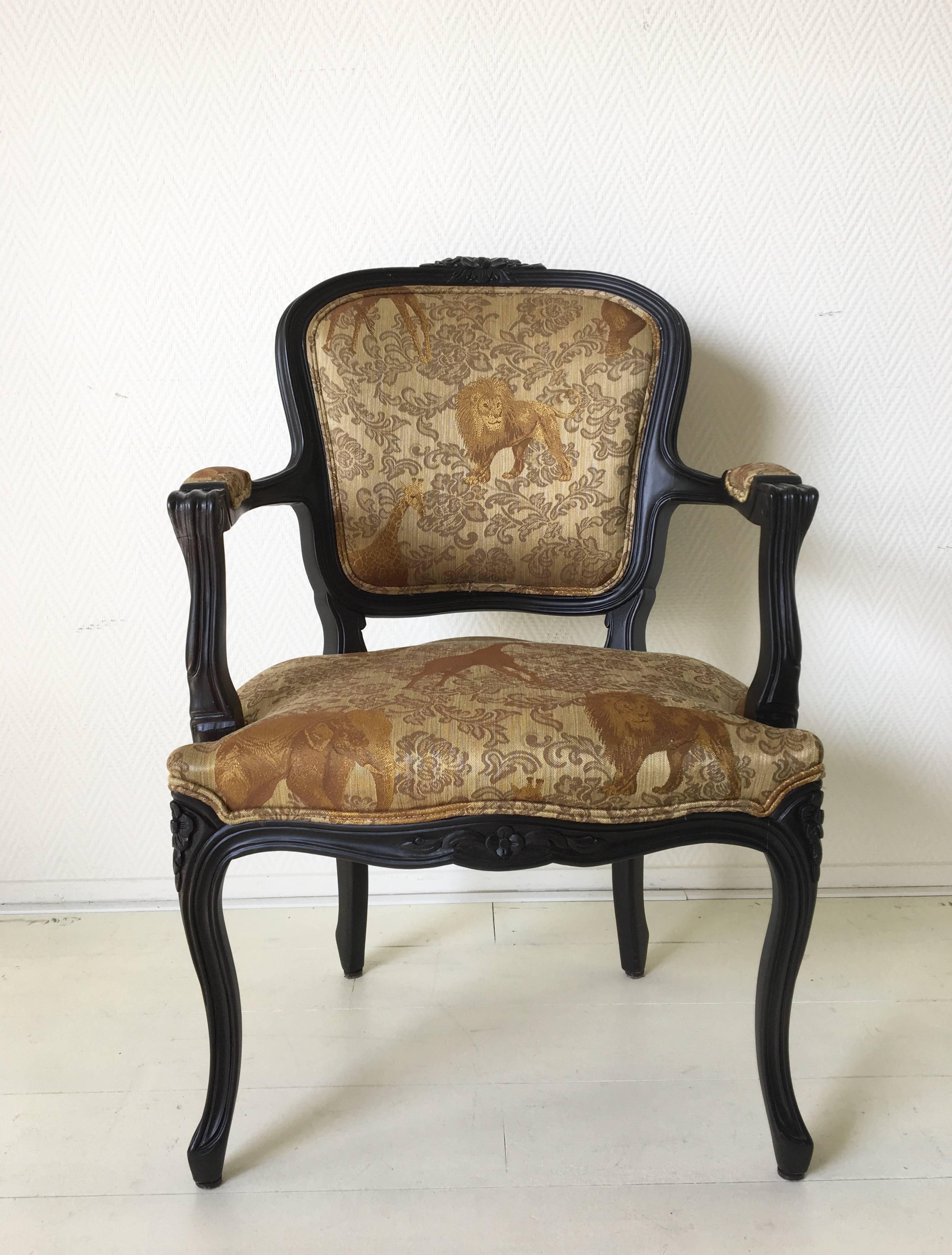 Exclusive design by the Spanish family company Ascension Latorre. The company is known for their hand made furniture. The chair features an ebonized wooden base with a gold colored upholstery with wildlife animals. This extraordinary piece remains