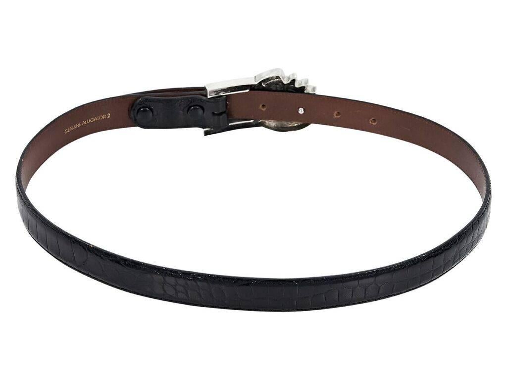 Product details:  Black alligator belt by Barry Kieselstein-Cord.  Adjustable sun buckle closure.  Silvertone hardware.  1