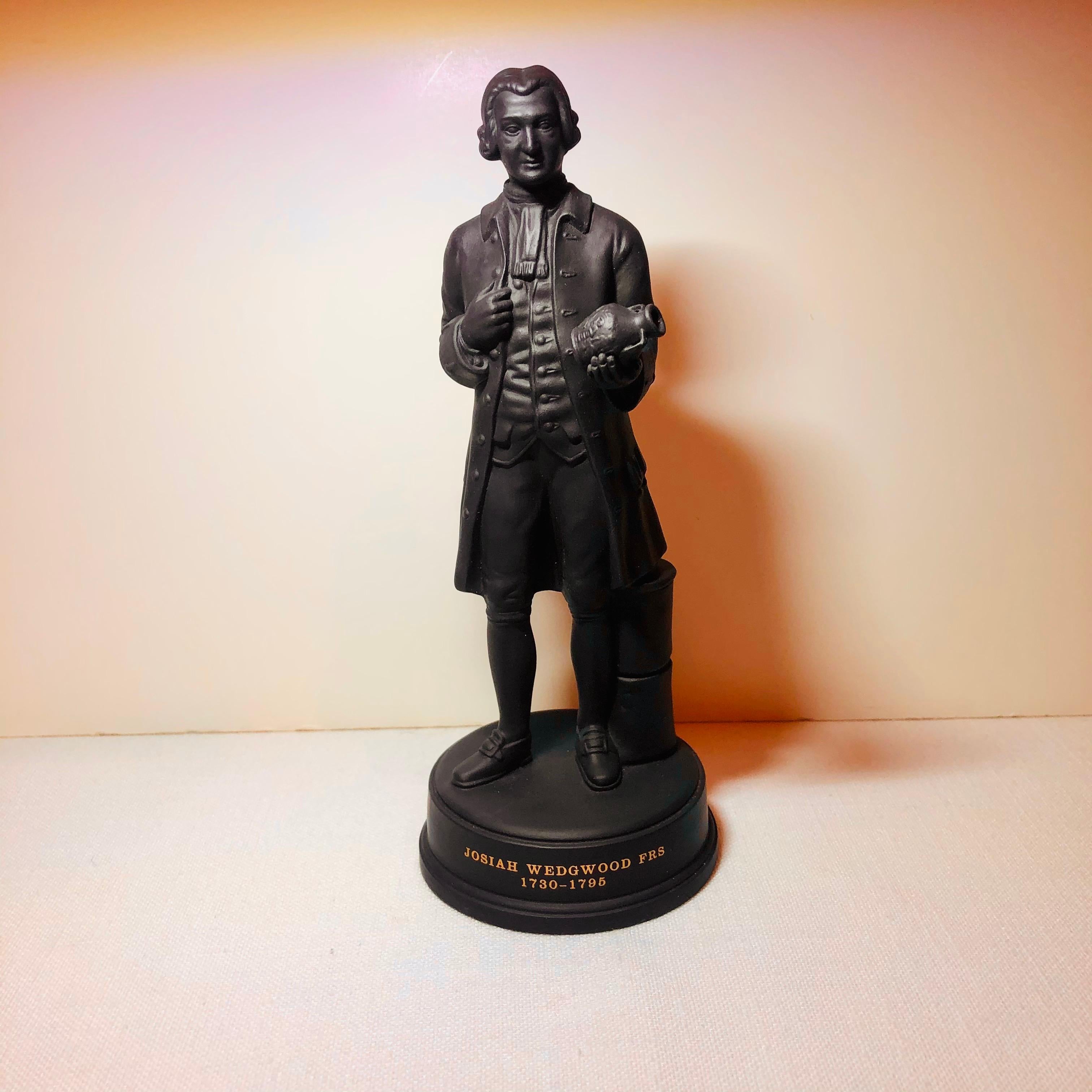 This is an important black basalt Wedgwood figure of Josiah Wedgwood, who is the founder of Wedgwood, holding his historic Portland vase, which was a proud work of art for Wedgwood. It is a beautifully modeled figure made at Wedgwood. It is 8.88