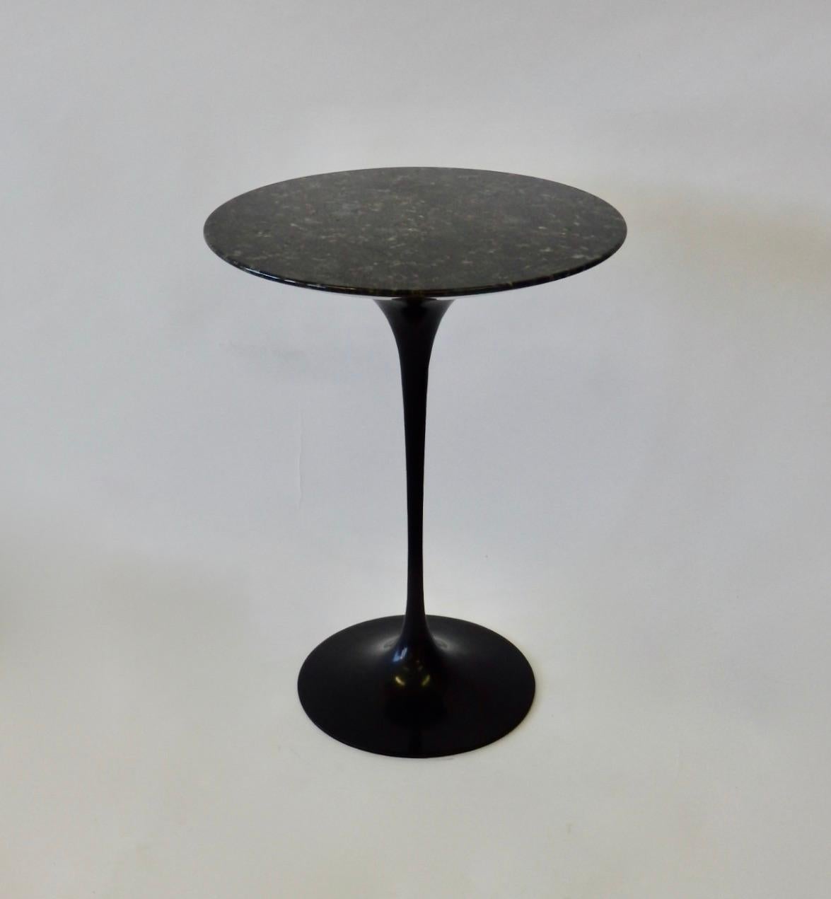 Black base Eero Saarinen designed Tulip table with custom dark stone top. Manufactured by Knoll.