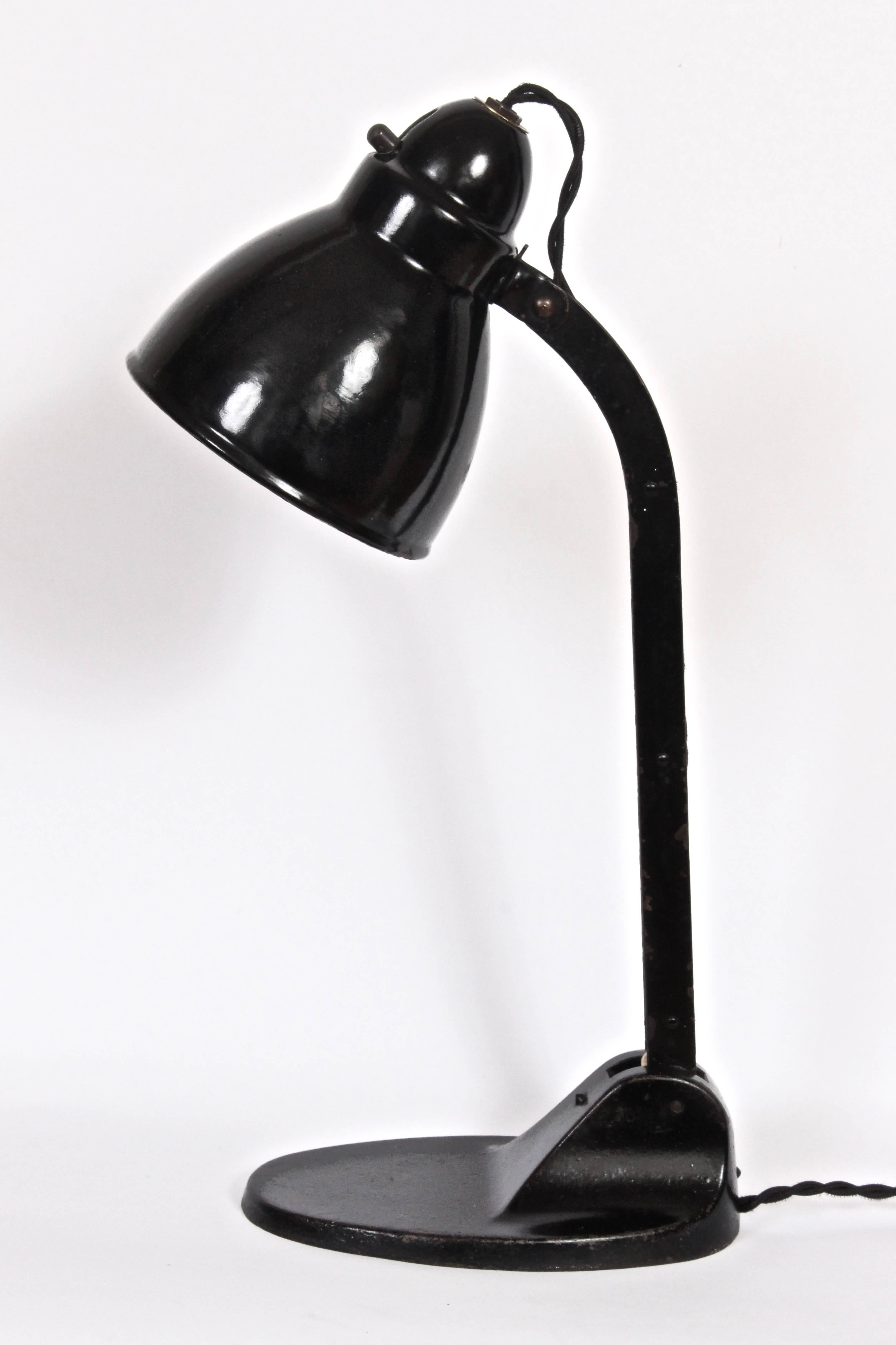 Timeless, Industrial and adjustable Viktoria Lampe table lamp in the style of Jacobus Johannes Pieter Oud. Featuring adjustable black enameled steel shade and column with sturdy black cast Iron base. Original toggle switch. Small footprint. Stamped