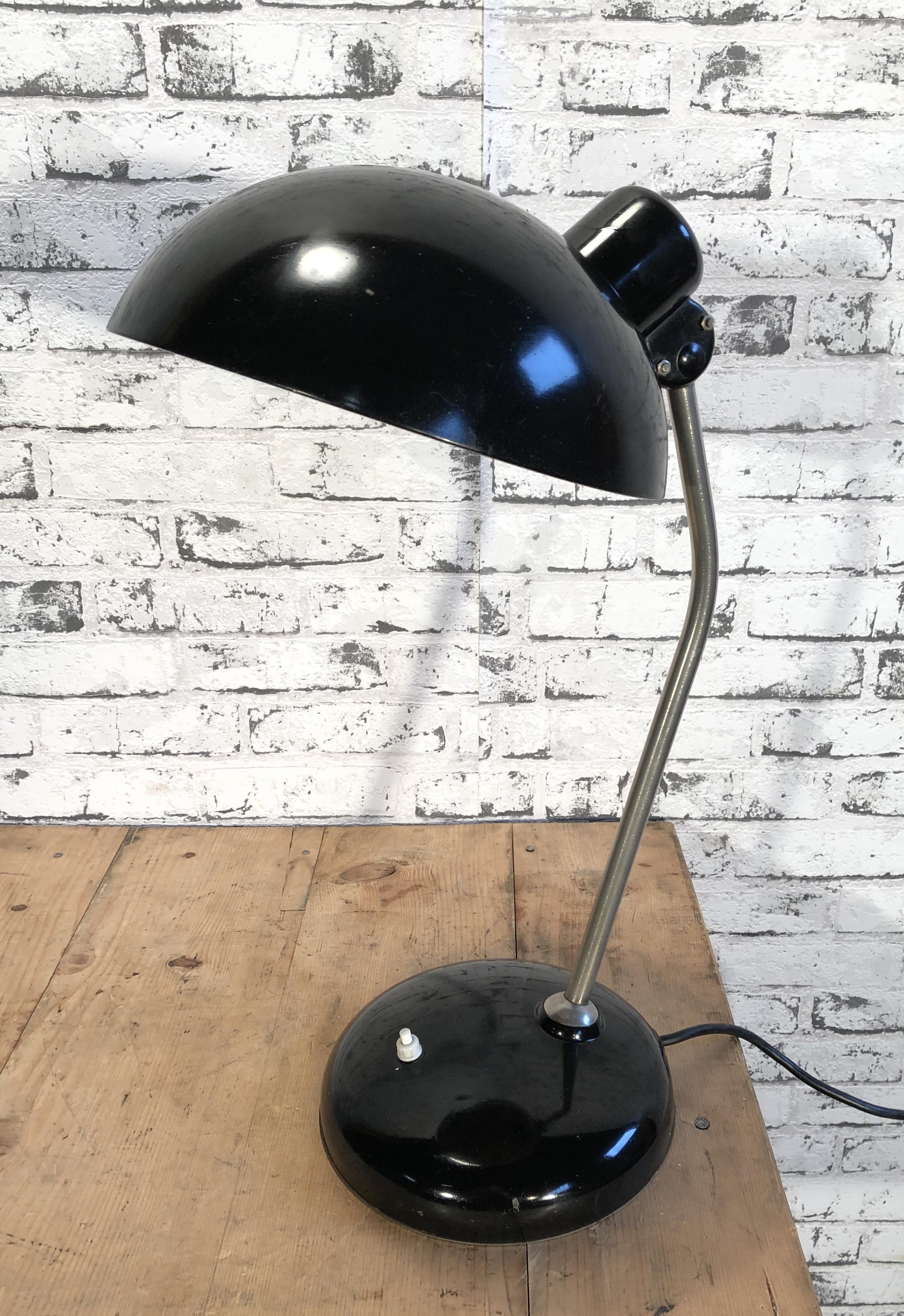 Black Industrial table lamp was made during the 1930s. It features a black shade and base, chrome-plated arm with two adjustable joints. Original socket for E 27 lightbulbs. Fully functional.