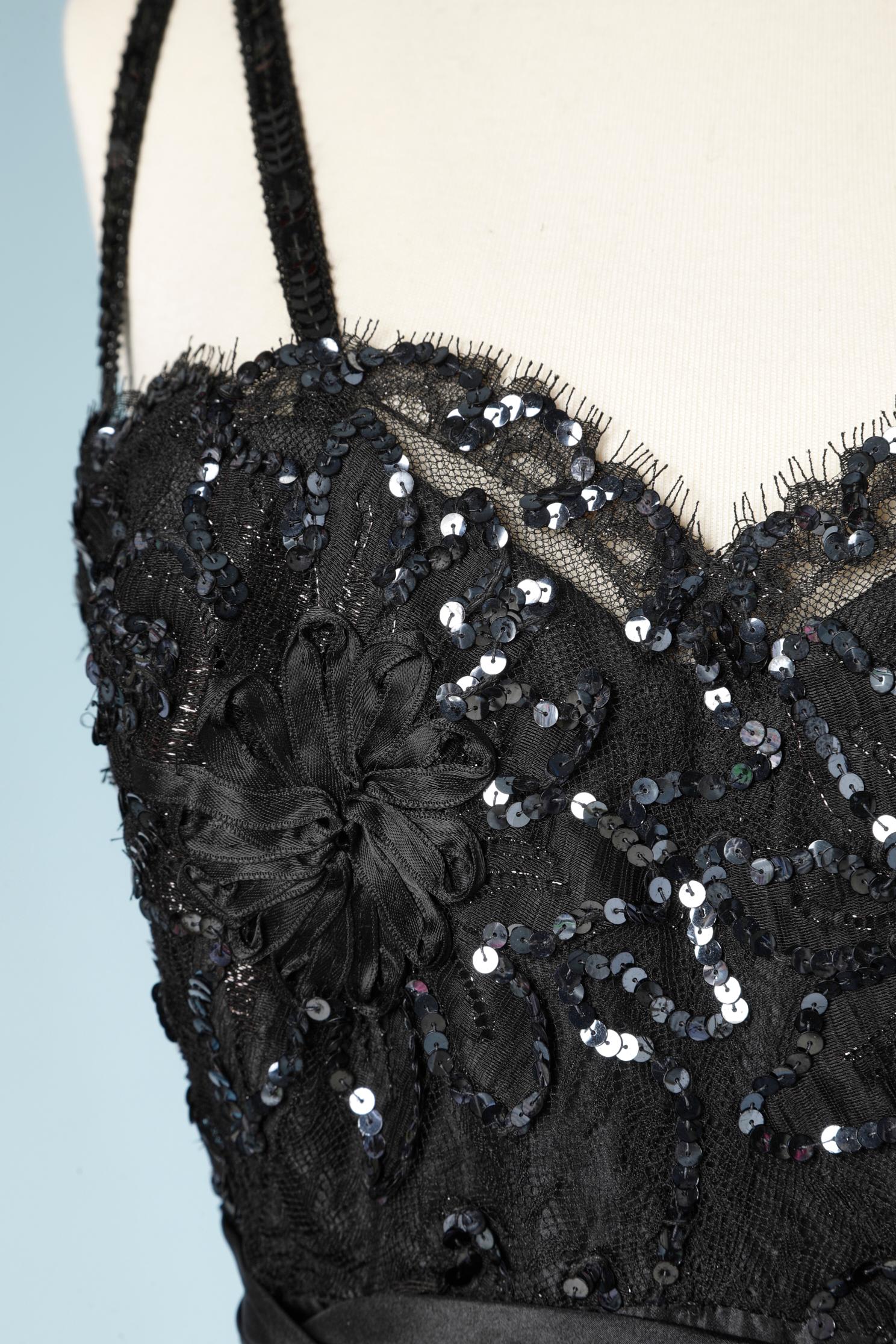 Black beaded and silk taffetas evening dress. Embroidered bustier with sequin and satin ribbons. Stiff tulle petticoat 
Underwire bra inside the bustier and waist band. Zip in the middle back. 
SIZE 42 (L) 
