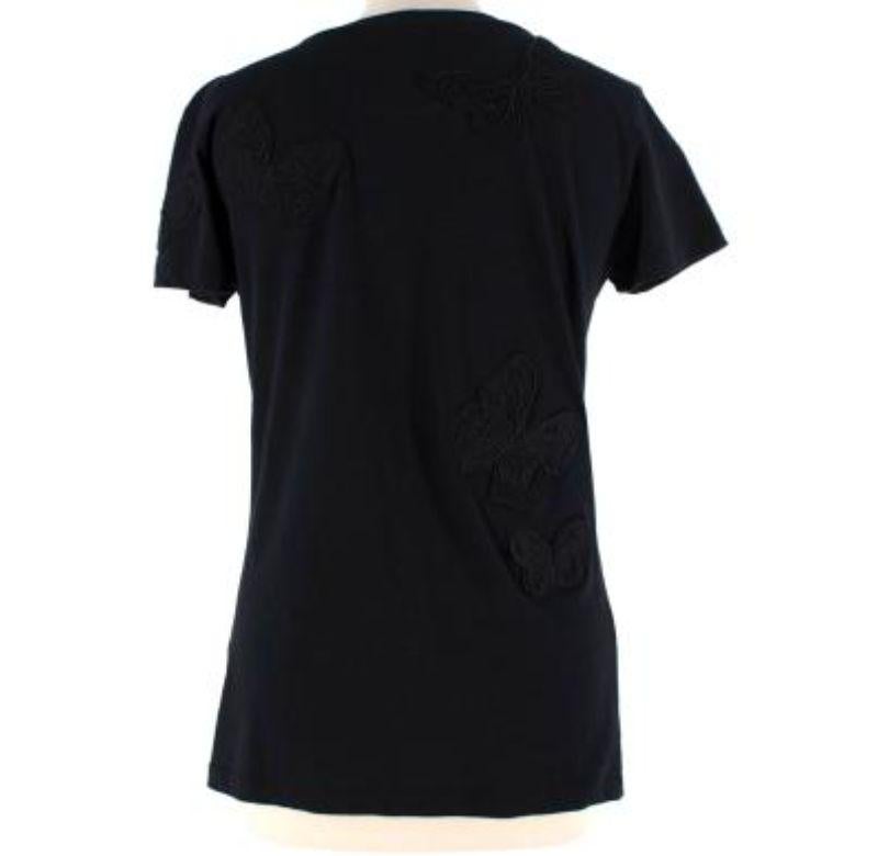 Valentino Black Beaded Butterfly Applique Cotton Jersey T-Shirt
 
 - Beaded tone on tone appliquéd butterflies 
 - Lightweight and soft cotton 
 - Cap sleeves 
 - Crew neckline 
 - Slim fit
 
 Materials: 
 100% Cotton
 
 Made in Italy 
 Dry clean