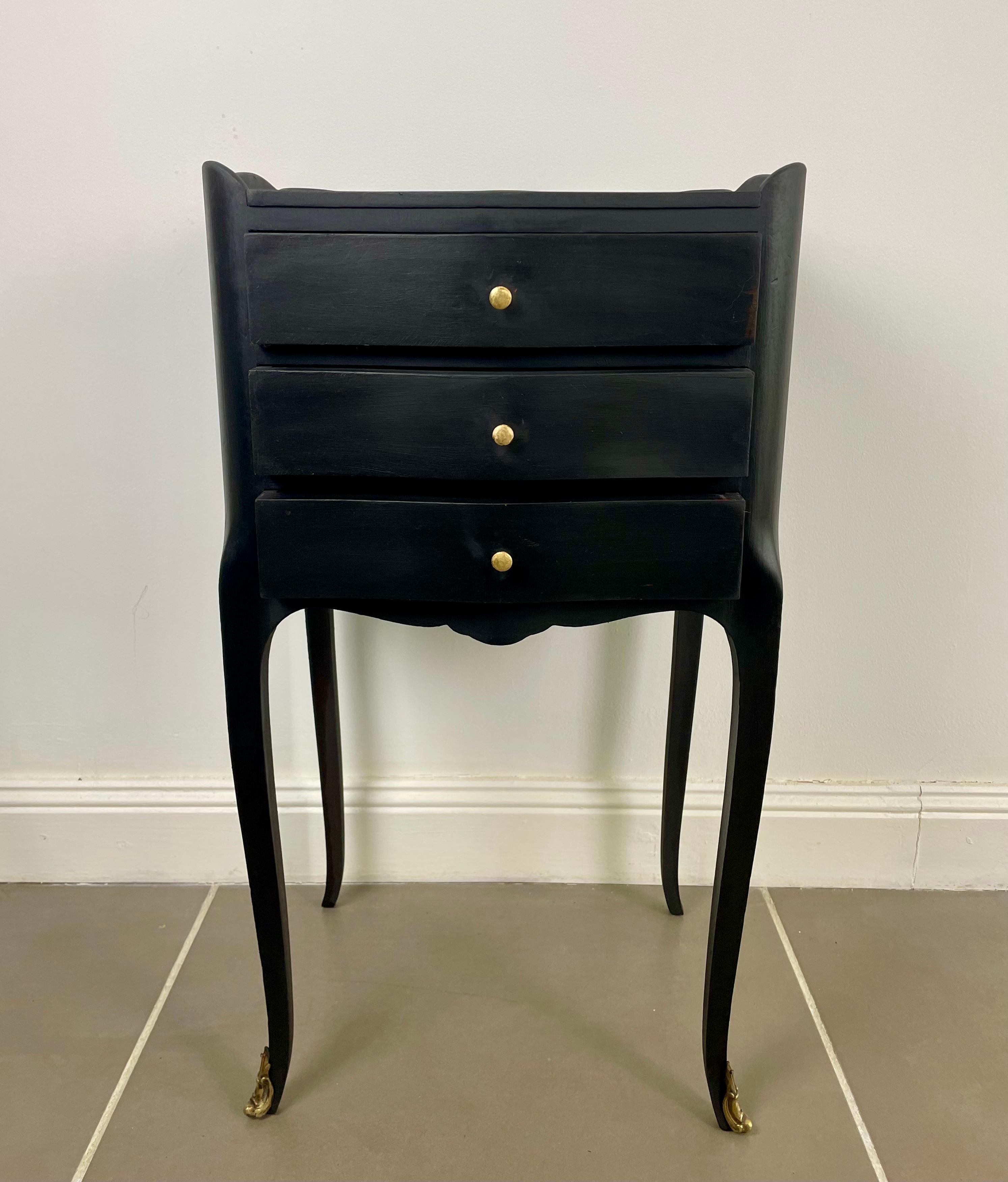 Very nice little black bedside table in the Louis XV style. The legs are slightly curved and the table is composed of three drawers.