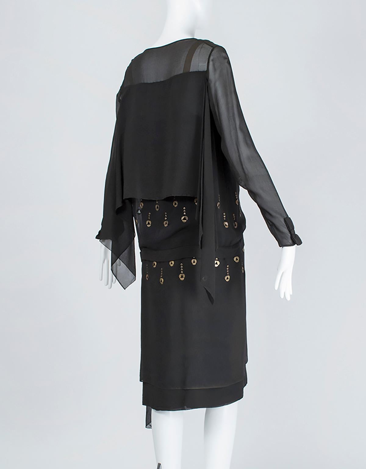 A dress that went around the world in 1924, this unusual frock features metal eyelets that gently chime when the wearer moves. An exotic masterpiece worthy of Callot Soeurs or Paquin.

Vintage knee-length drop waist dress with square neckline and