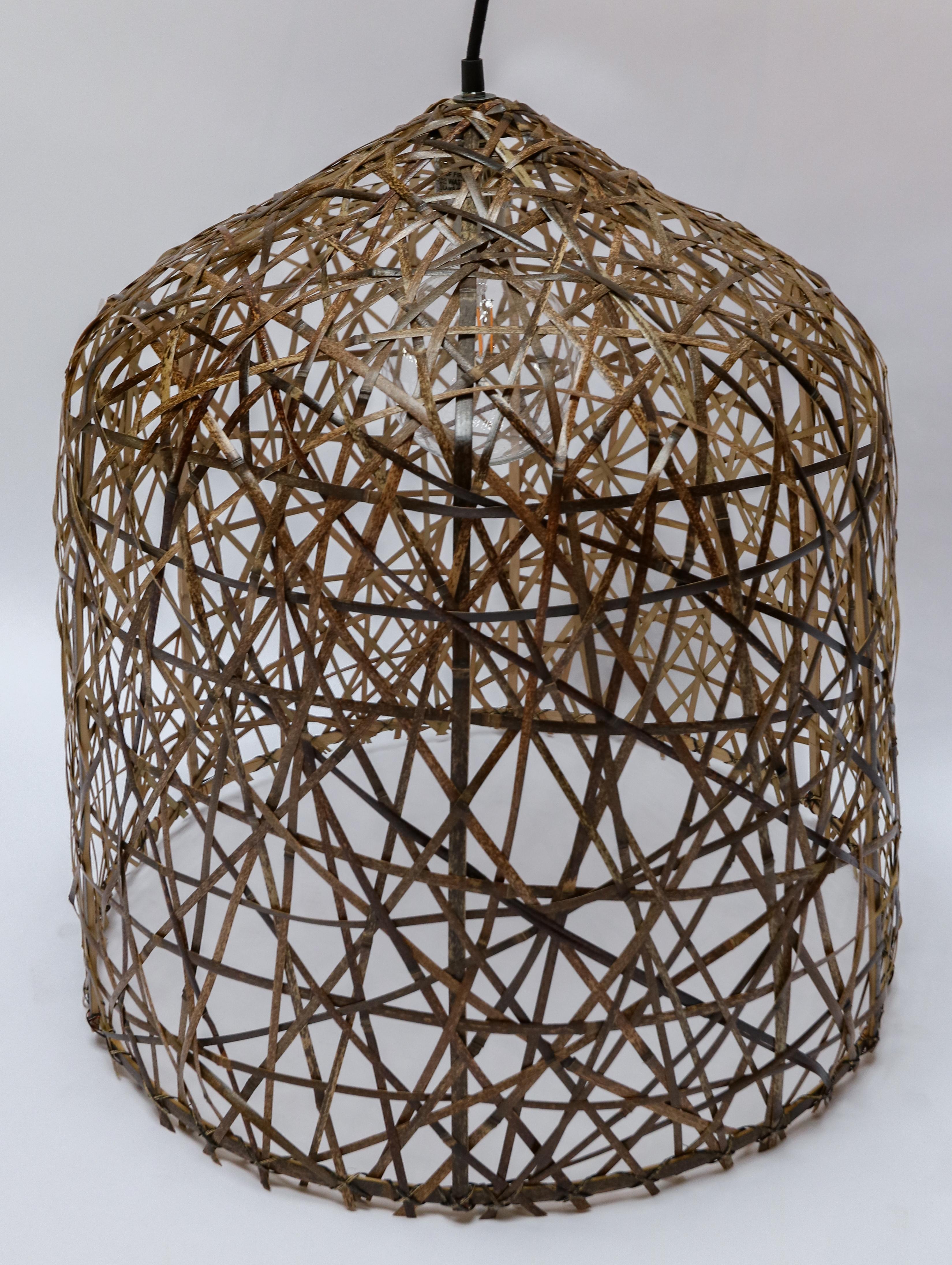 The inverted-cup shape of the Black Bird’s Nest Medium pendant has a shade woven from repurposed bamboo strips. It is the creation of Ay Illuminate, a company that has garnered quite a reputation for using this material as a building block for its