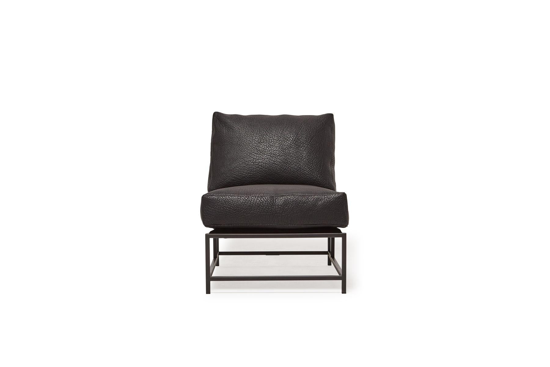 Sleek and refined, the Inheritance Collection chair by Stephen Kenn is a great addition to nearly any space. 

This chair is upholstered in a beautifully textured pebbled black bison leather. The foam seat cushion has been wrapped in down,