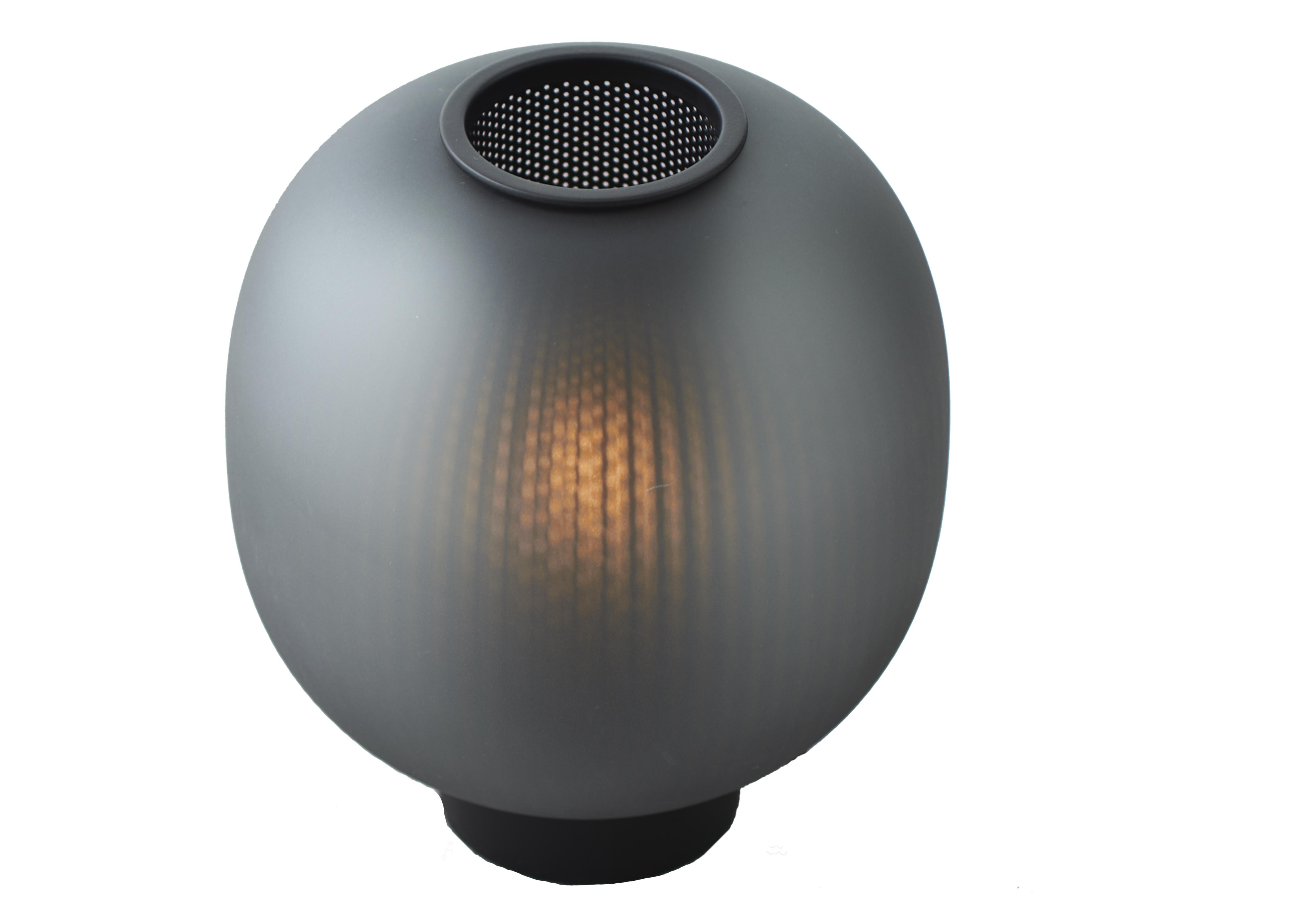 Black Bloom Table Lamp by Resident
Dimensions: D 24 x H 28.5 cm
Materials: Glass, Stainless Steel.


The Bloom Pendant’s super-elliptical form is inspired by the gentle dynamic flow of paper lanterns. Transparency and light create a glorious lit
