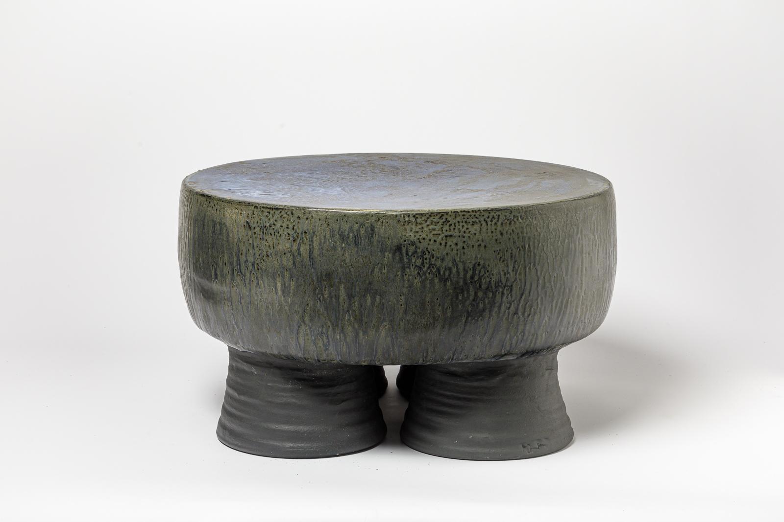 Black/blue and grey/green glazed ceramic stool or coffee table by Mia Jensen. 
Artist signature under the base. 2023.
H : 12.2’ x 21.3’ inches.