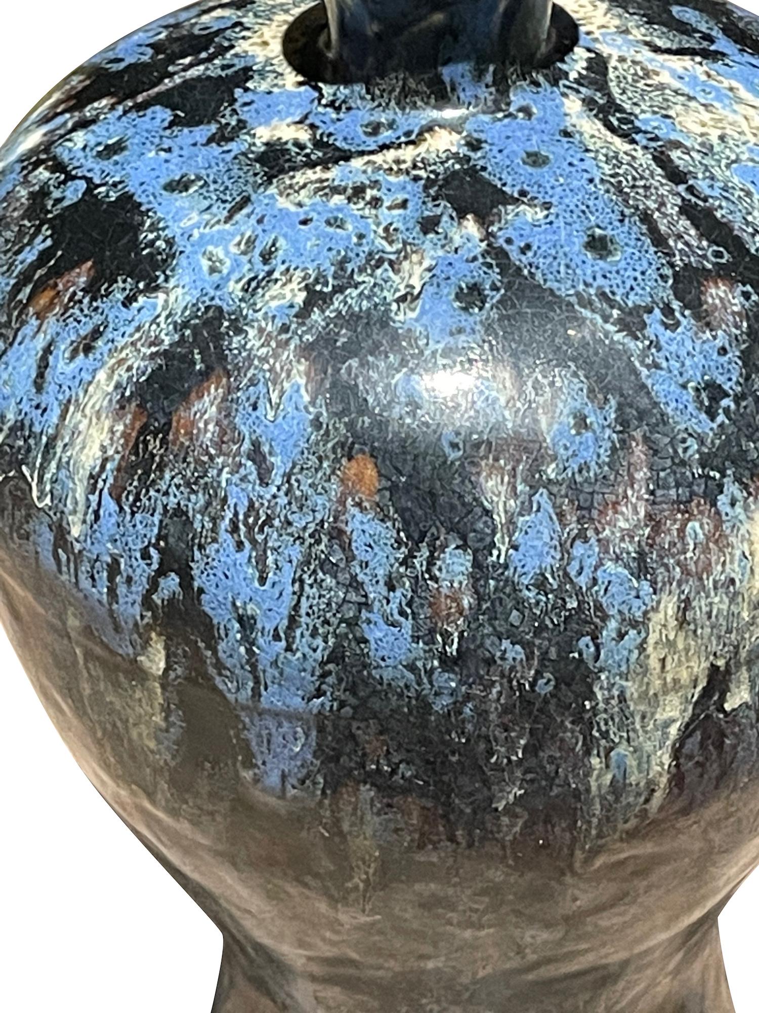 Contemporary Chinese curved shaped vase with black, blue and white splatter glaze.
One of several from collection of similar glaze in various shapes.
Sold individually.
