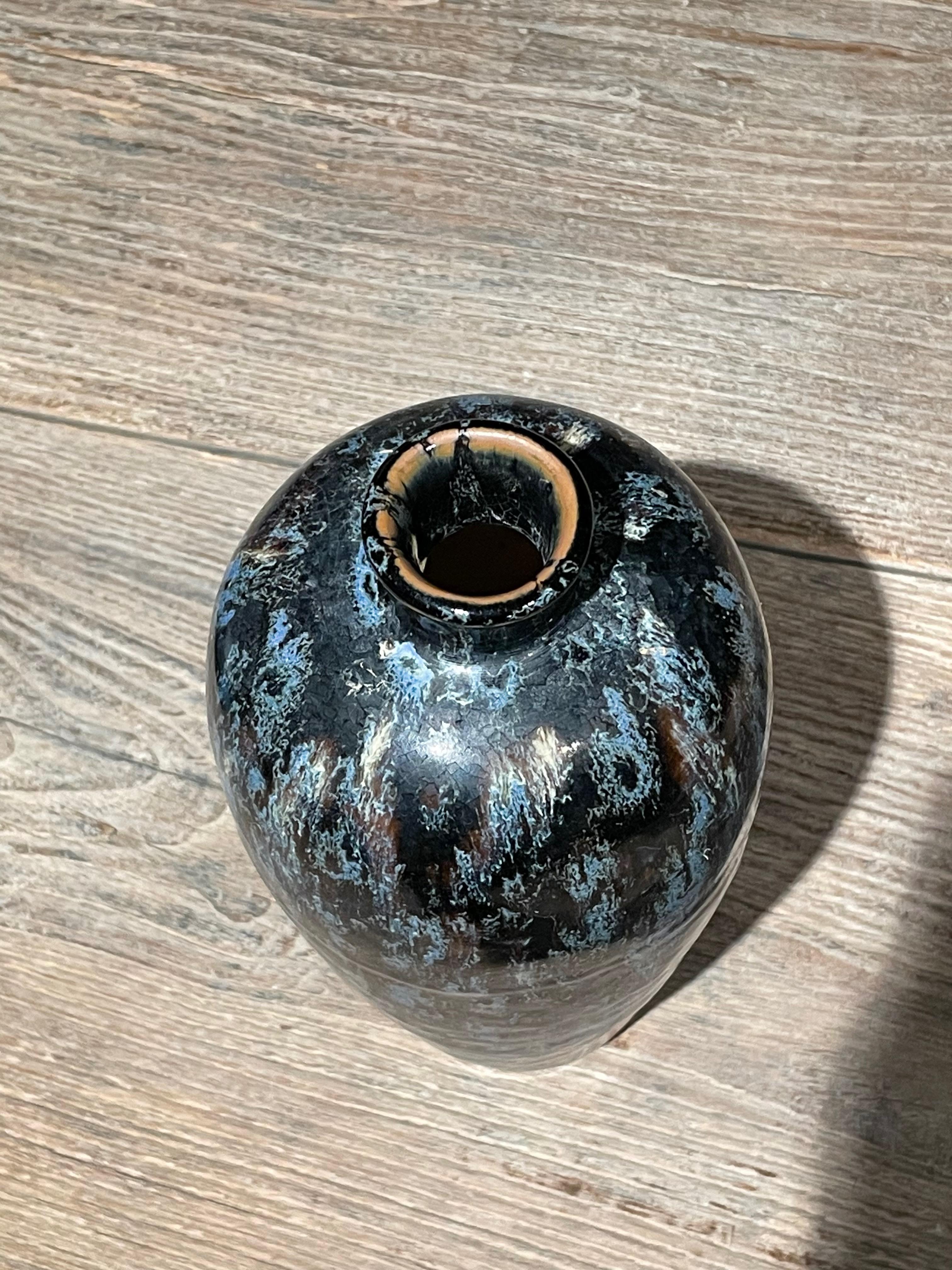 Contemporary Chinese thin spout vase with black, blue and white splatter glaze.
One of several from collection of similar glaze in various shapes.
