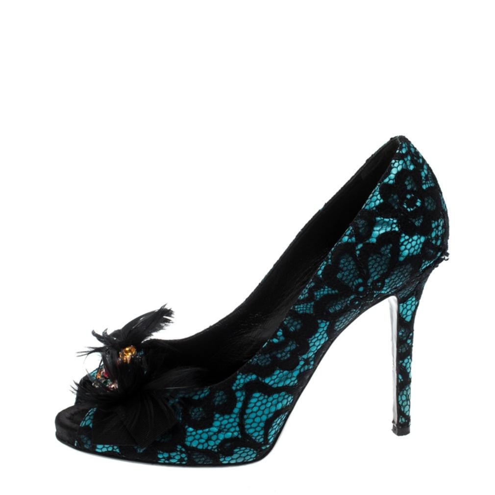 Look fabulous in this pair of pumps, crafted out of lace and satin. Add value to your ensemble by wearing this pair of Dolce and Gabbana pumps, decorated with embellishments and feathers on the peep-toed vamps. This black pair s complete with high