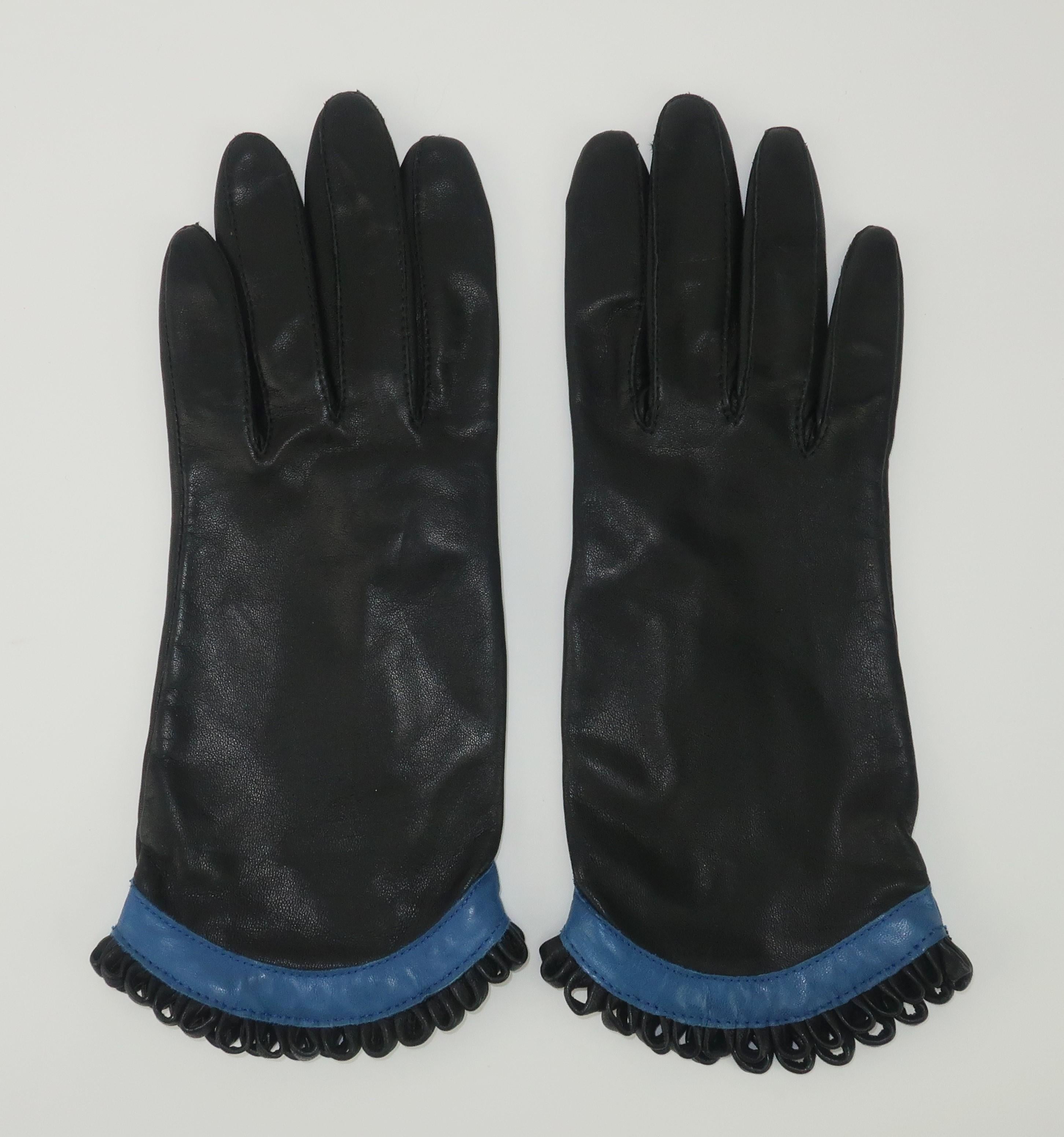 Black and royal blue leather gloves with looped fringe cuffs and nylon lining by Fownes.  Perfect touch of whimsy for a winter wardrobe.
CONDITION
Very good previously owned condition with little to no wear. 
SIZING & MEASUREMENTS
Marked a size 6