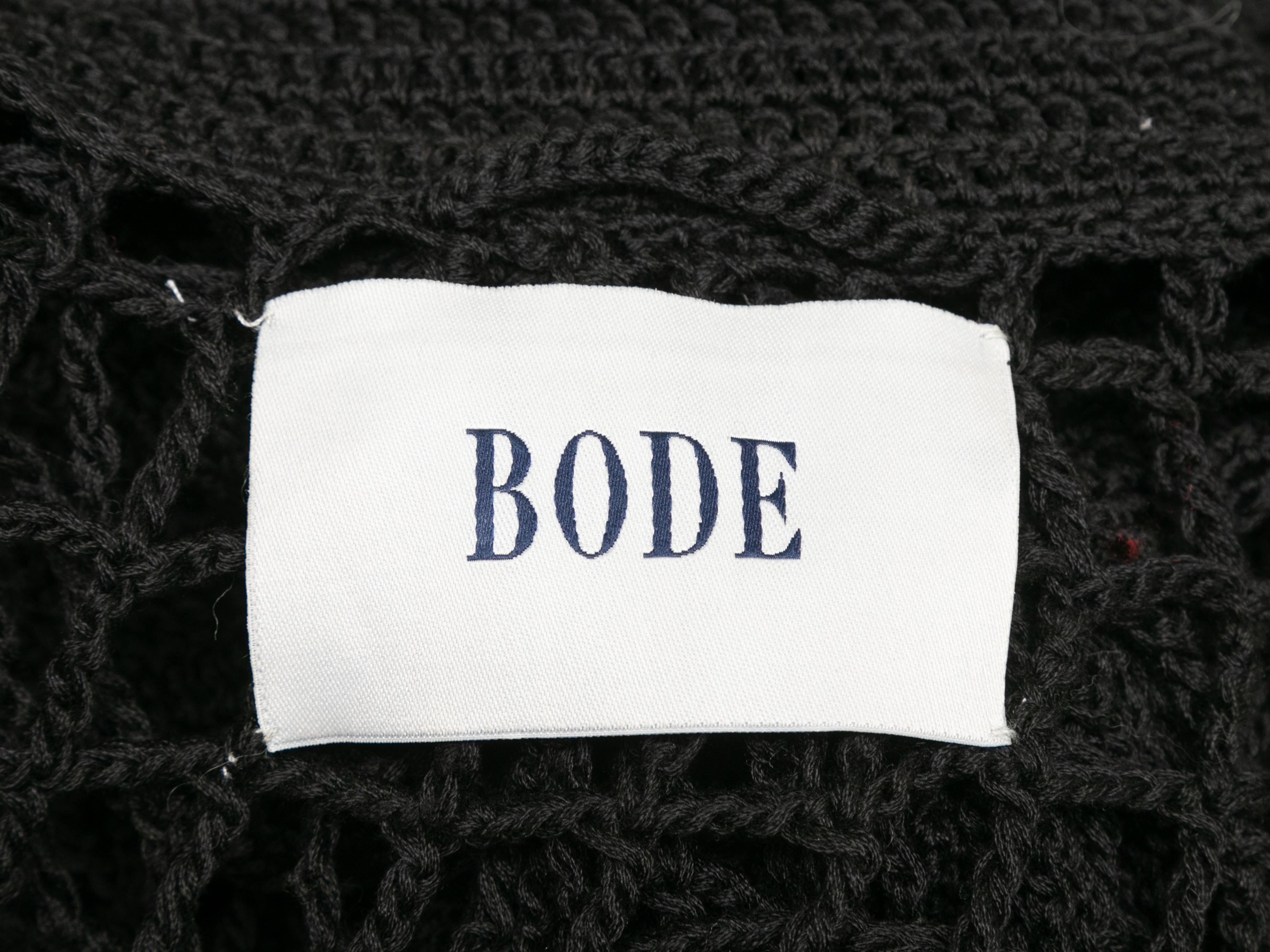 Black open crochet cardigan by Bode. Pointed collar. Floral accents throughout. Button closures at front. 41