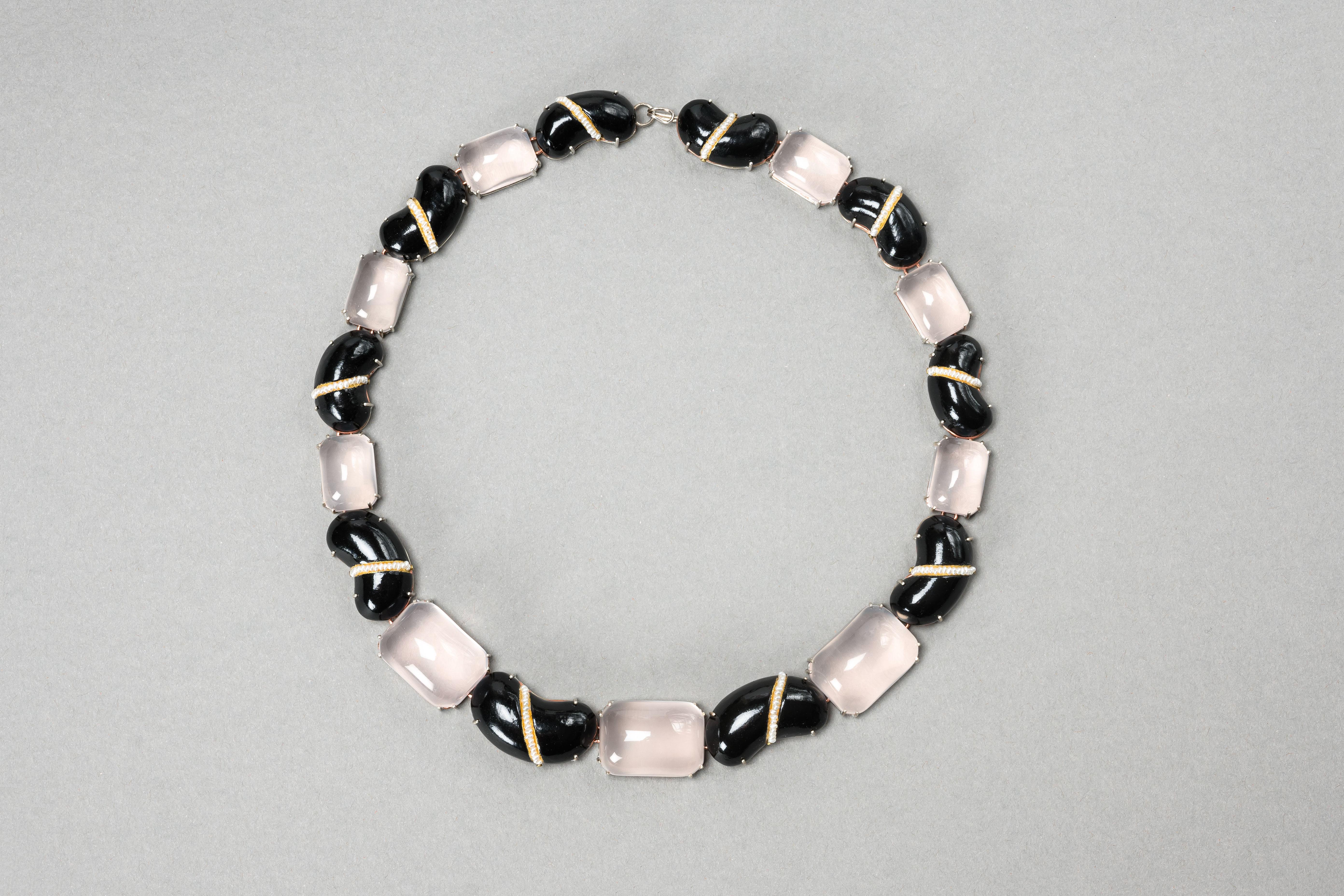 Necklace “Faba”, 2023 , is a one-of-a-kind contemporary author jewelry by italian artist Gian Luca Bartellone.
Materials: papier-mâché, silver, copper, rose quartz, pearls, gold leaf 22kt.

Sober but rich elegance – this style will get you noticed!
