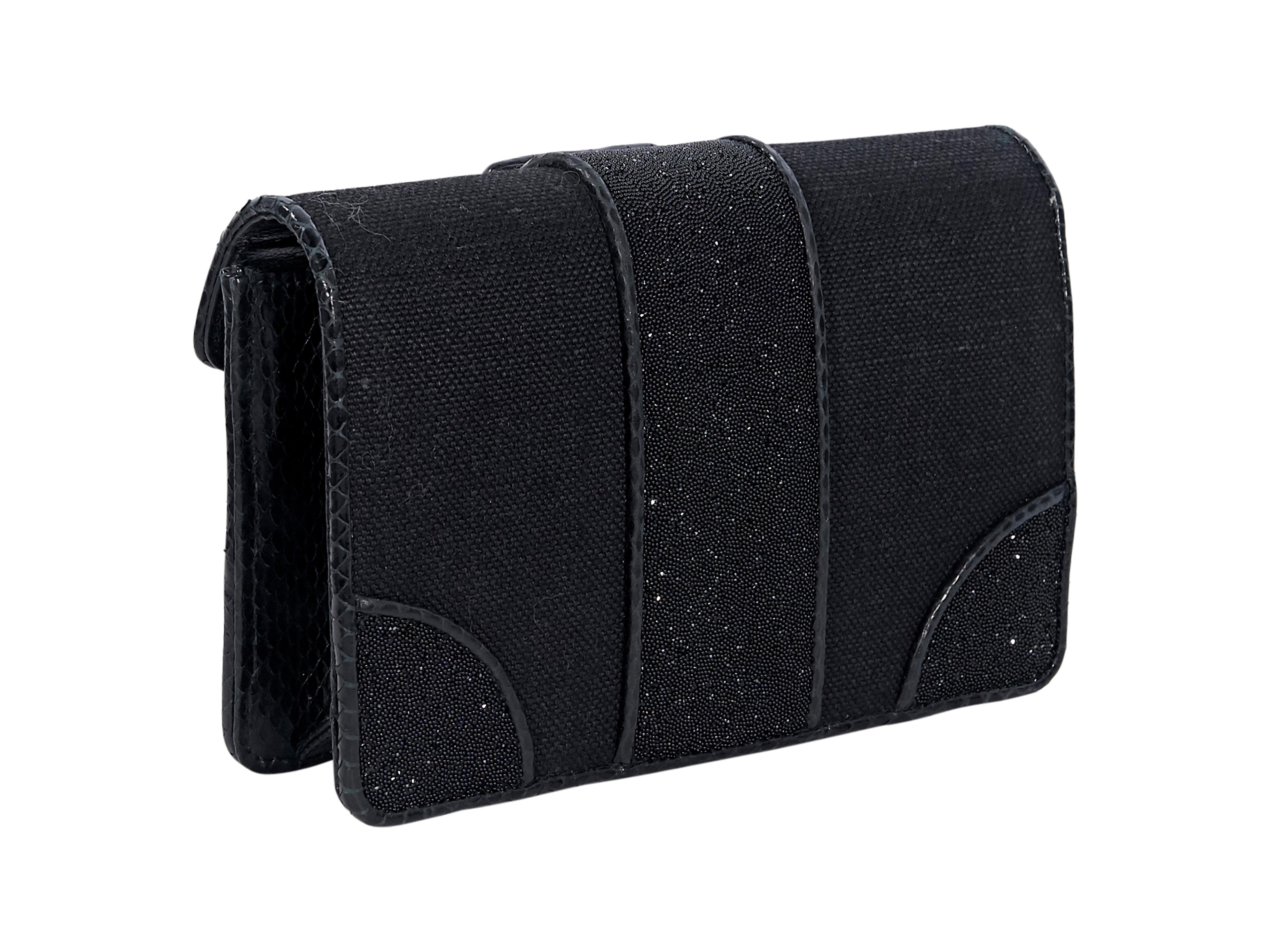 Product details:  Black patterned snakeskin-trimmed crystal-embellished canvas clutch by Bottega Veneta.  Trimmed with snake skin-embossed leather.  Front flap with magnetic closure.  Suede lined interior. Pair yours with a leather mini dress. 7.5