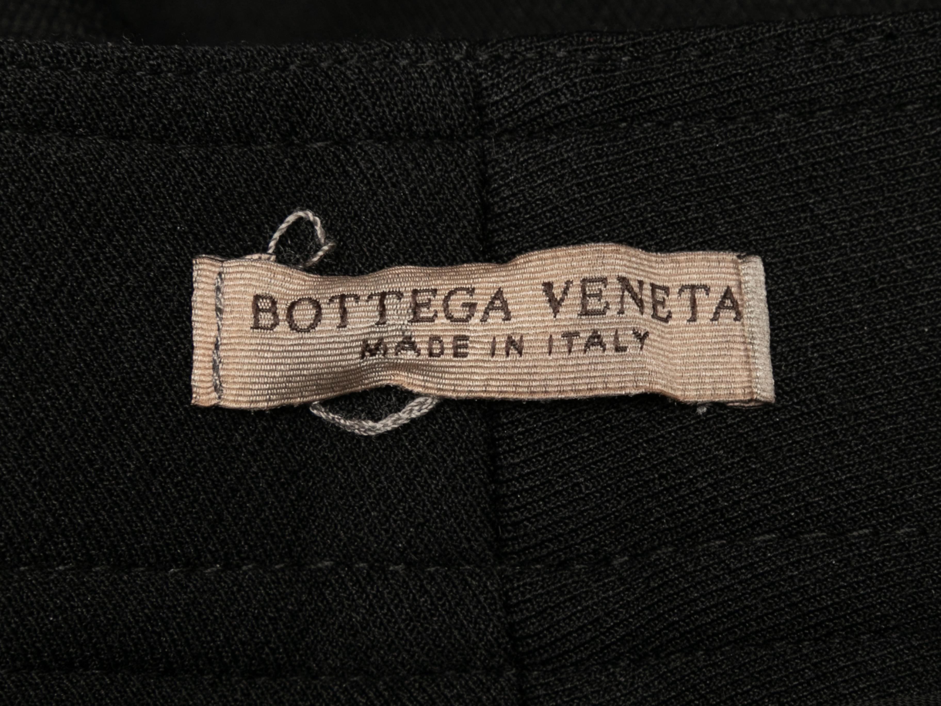 Black straight-leg trousers by Bottega Veneta. Zip closure hip pockets. Front zip and hook-and-eye closures. 31