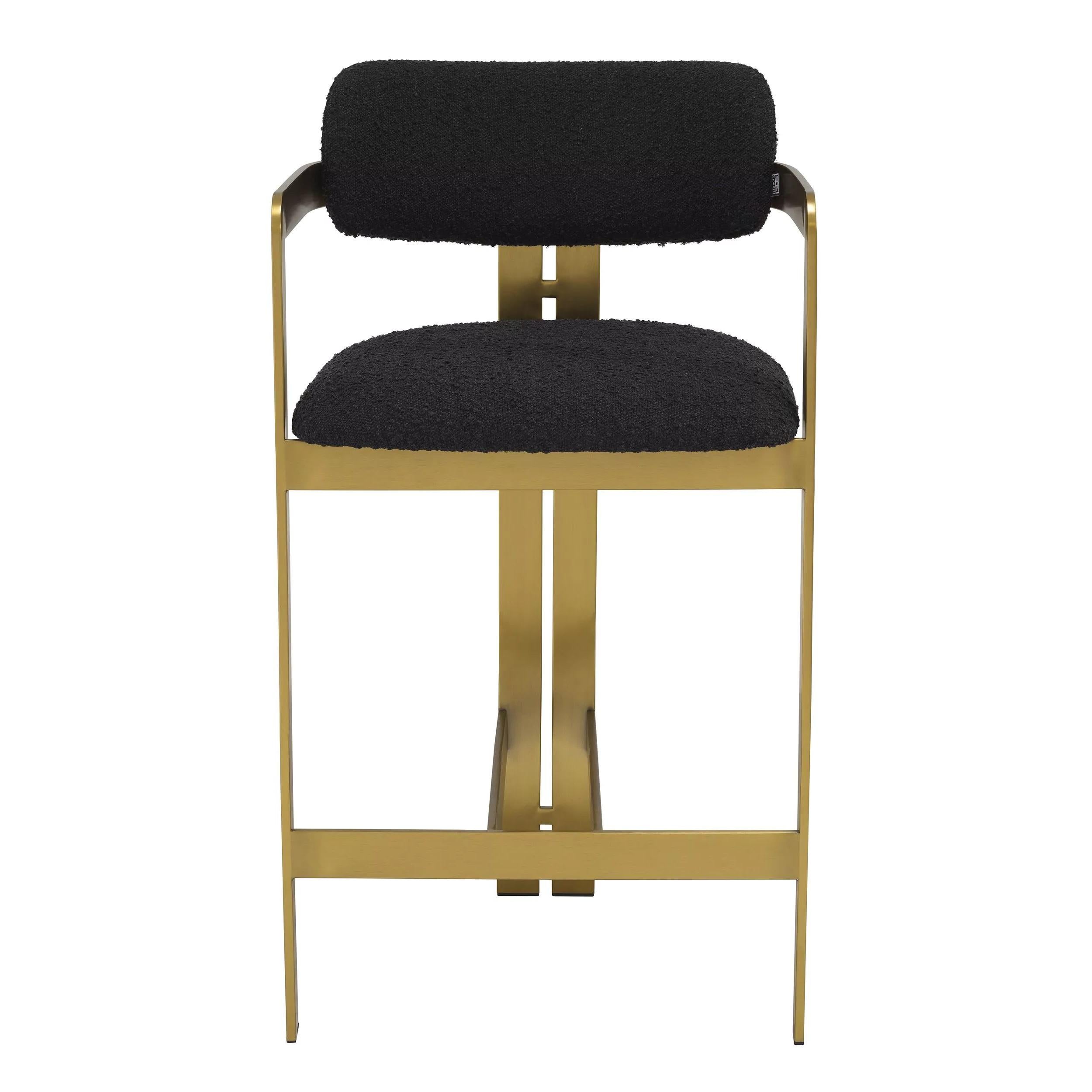 Counter bar stool in bouclé fabric and brass finishes.
