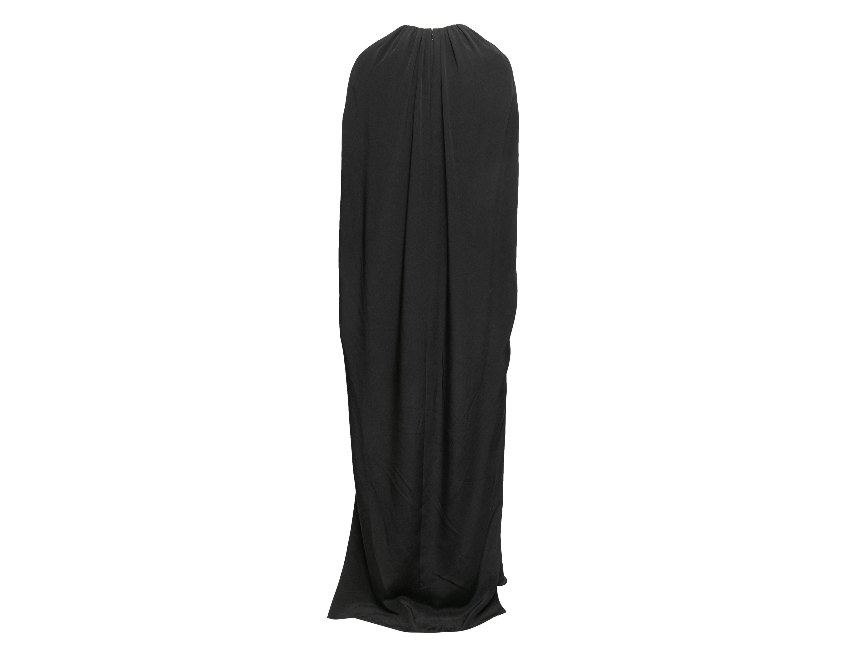 Black silk tailored cape gown by Brandon Maxwell. Ruching at crew neckline. Zip closure at center back. 34