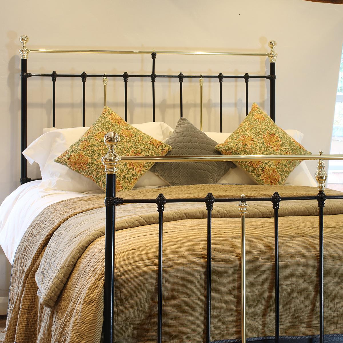 Antique bed in black with straight brass top rail, decorative castings and central brass trumpet.

This bed accepts a UK King size or US Queen size (5ft, 60in or 150cm wide) base and mattress set.

The price includes a standard firm bed base to