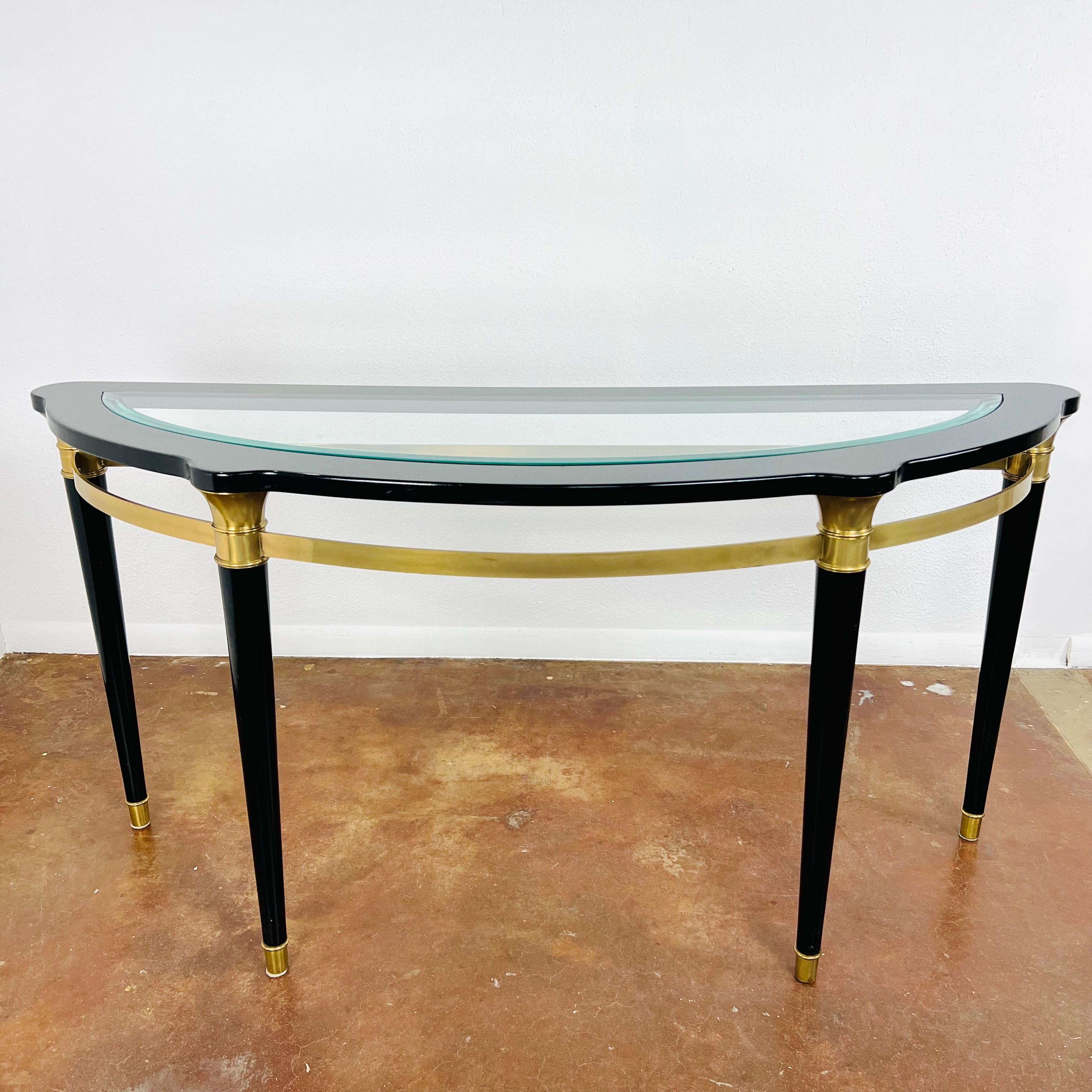 Hollywood Regency Style Demi-Lune Console Table with Glass Top and brass trim. Small chip at edge of glass and minor dings on legs (see photos for details).