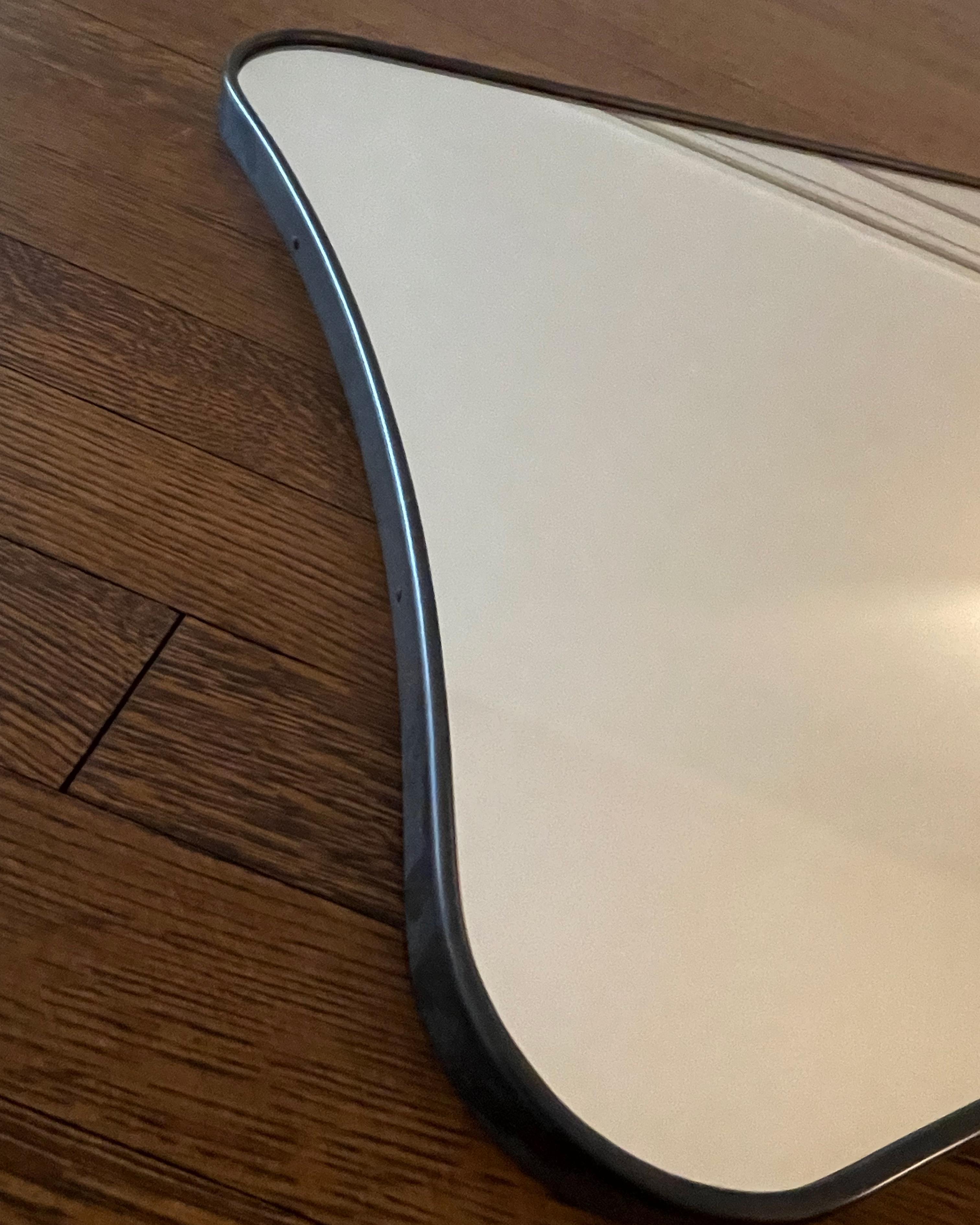 Gio Ponti-styled designed lightly curved F.A. 33 Mirror (1933) in Black Brass for FontanaArte made in Italy. 