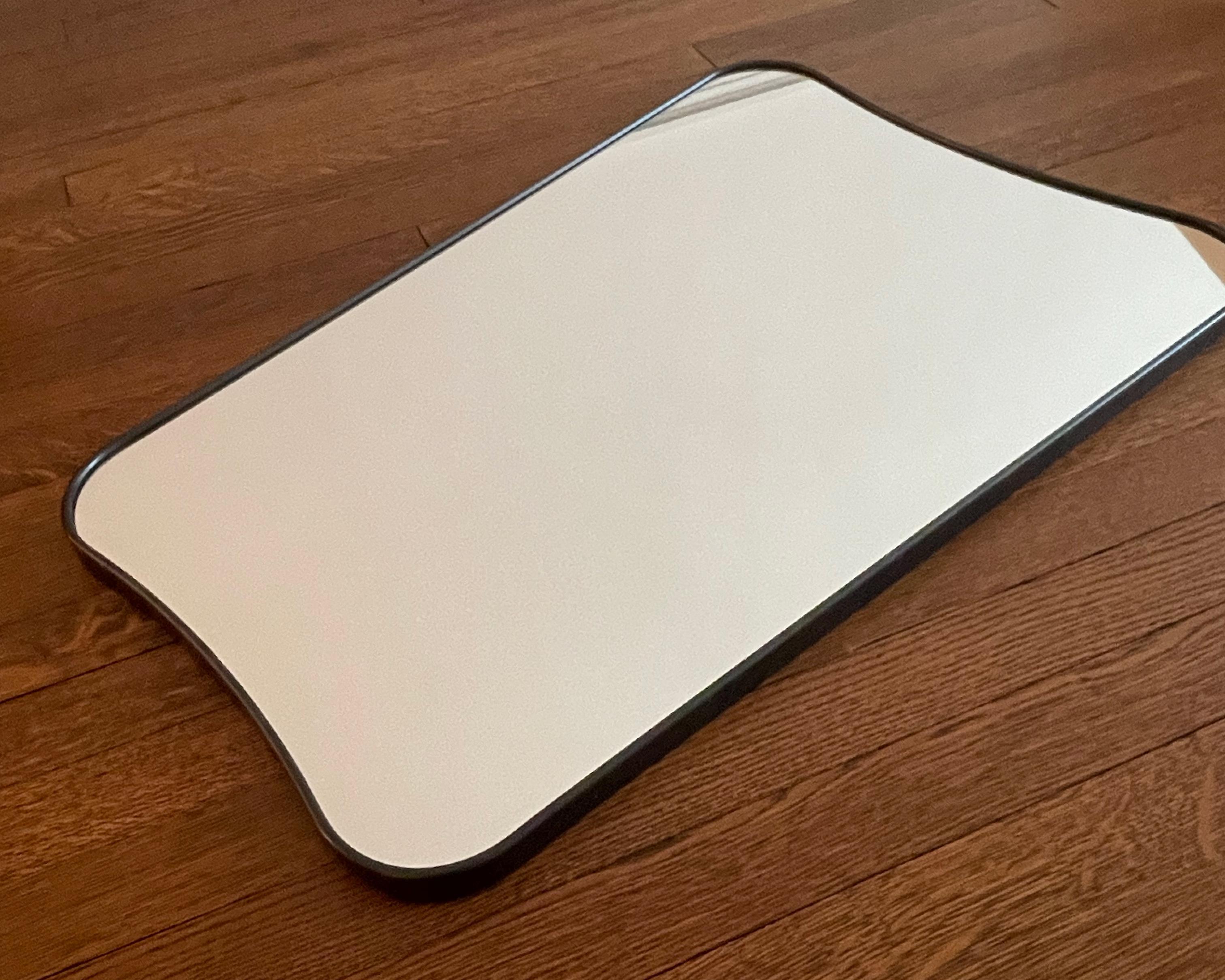 curved brass mirror