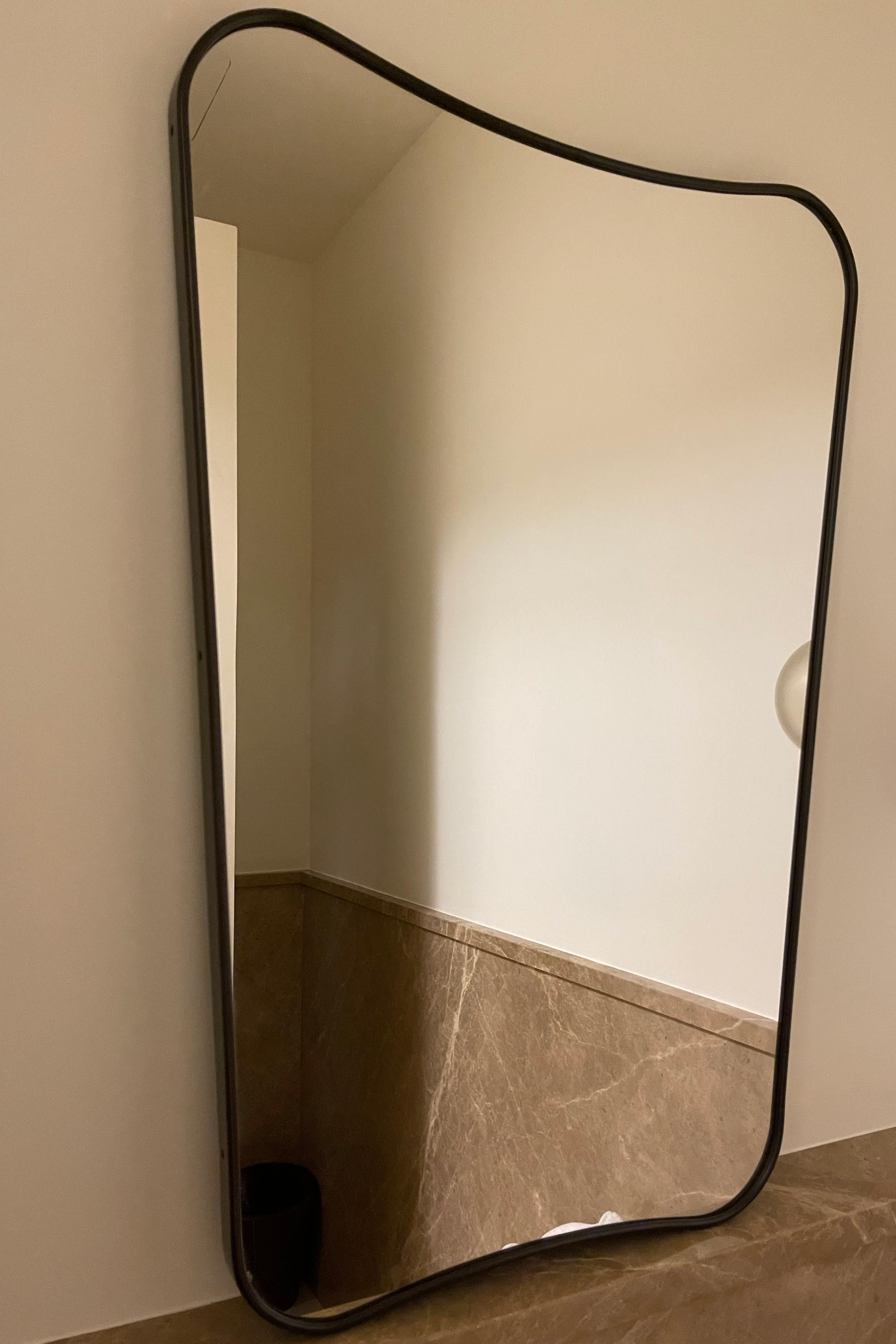 Italian Black Brass Sleek Curved Mirror Attributed to Gio Ponti