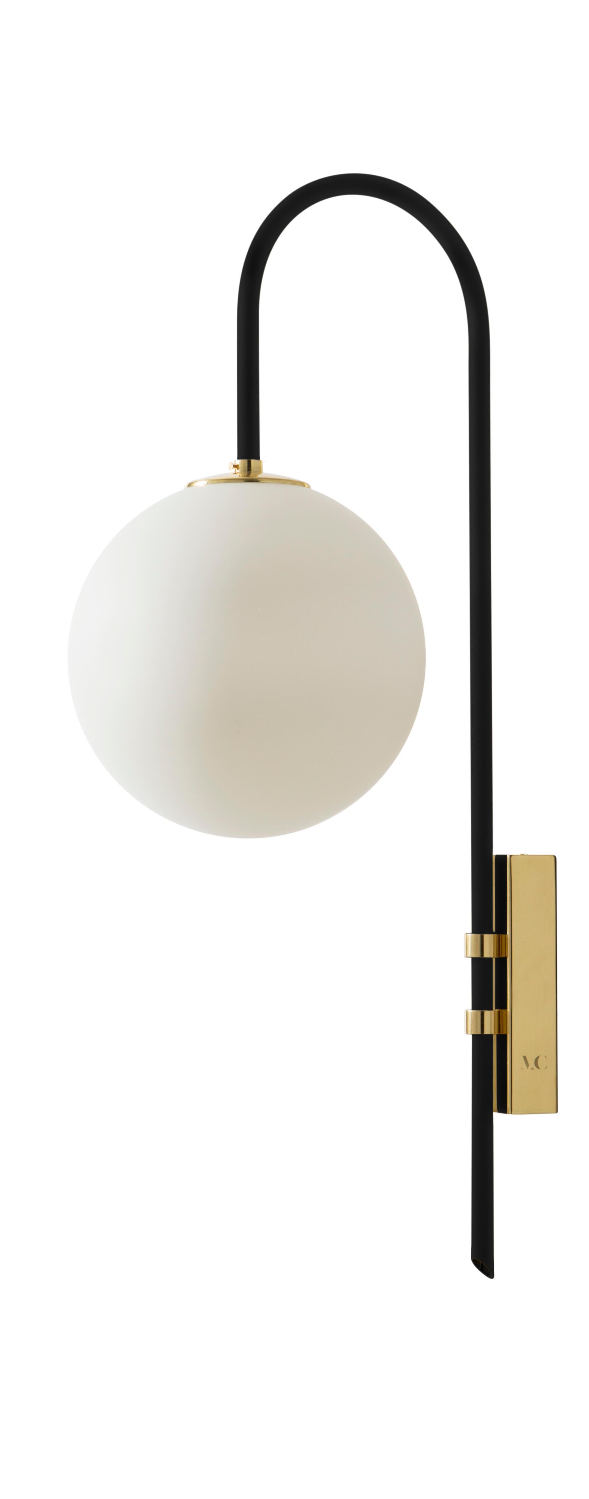 Black brass wall lamp 06 by Magic Circus Editions.
Dimensions: H 77 x W 25 x D 36.5 cm.
Materials: smooth brass, mouth blown glass.
Sphere Dimensions: 25 cm.

Available finishes: brass, nickel.
All our lamps can be wired according to each