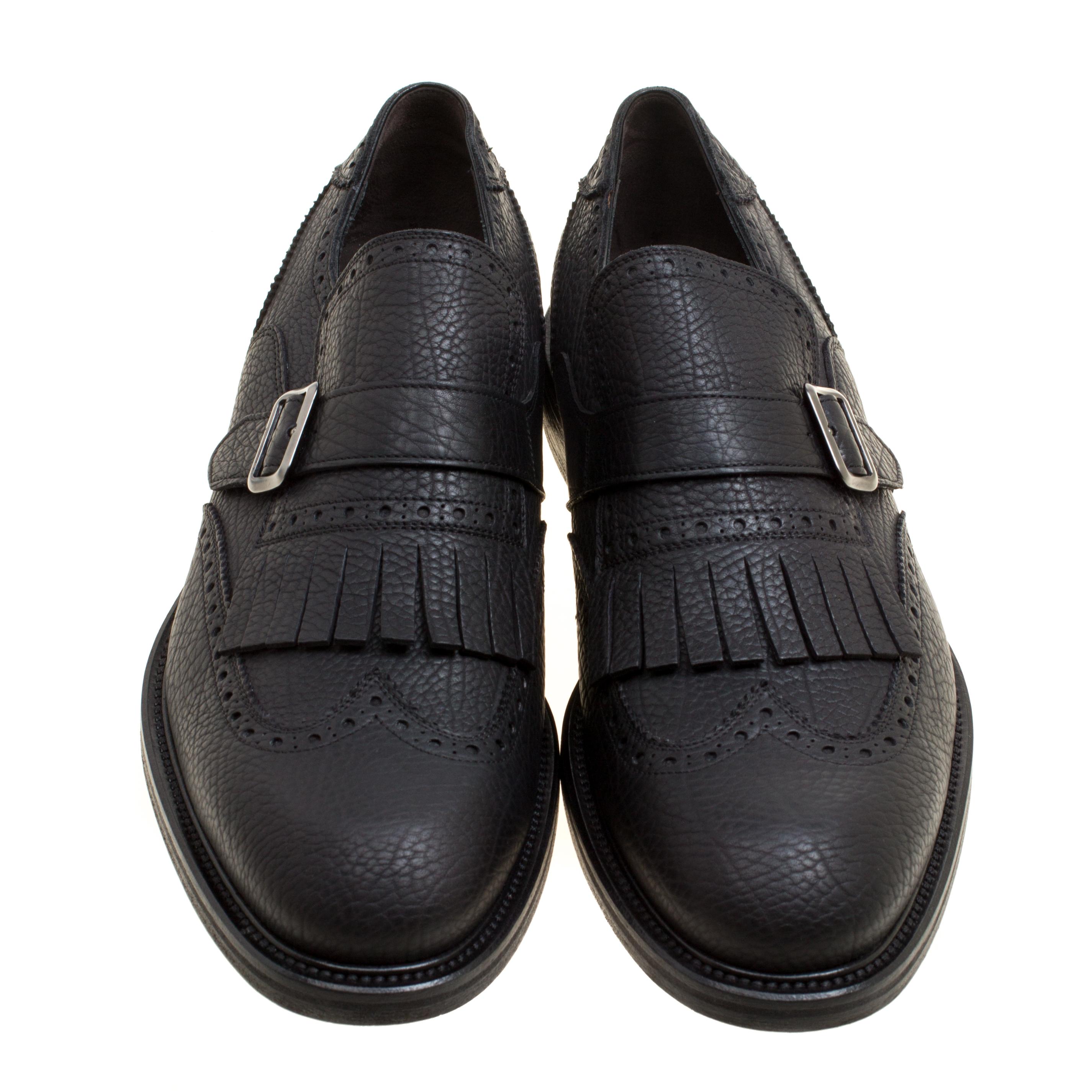 Take each step with style in these loafers from Salvatore Ferragamo. Crafted from leather, they carry a modern design of belts, wingtips, and fringes, in a timeless black shade with every stitch on them giving praise to quality and durability. The