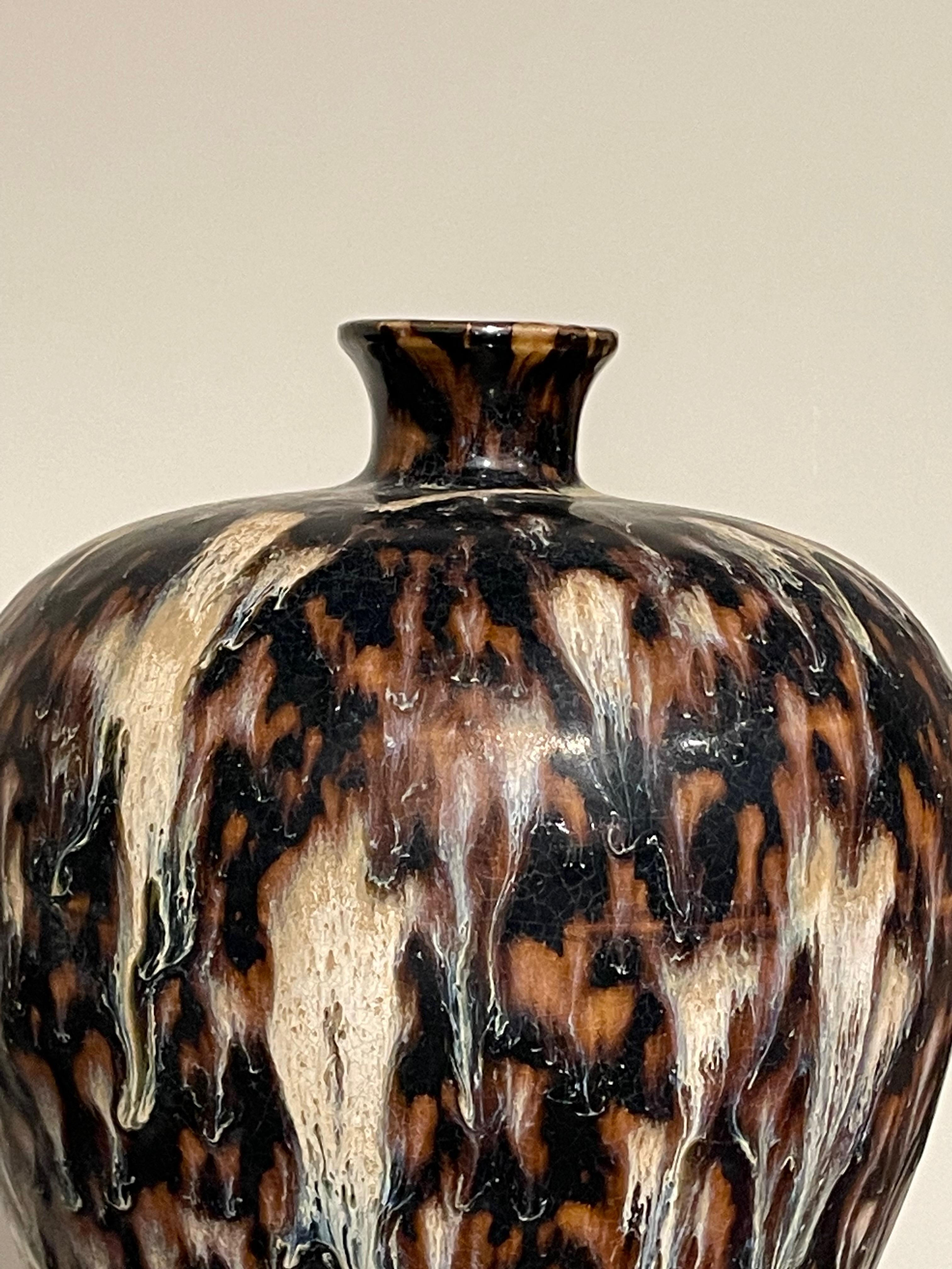 Contemporary Chinese hour glass shaped vase with tortoise effect glaze.
Black, brown and cream colors.
Two available and sold individually.
