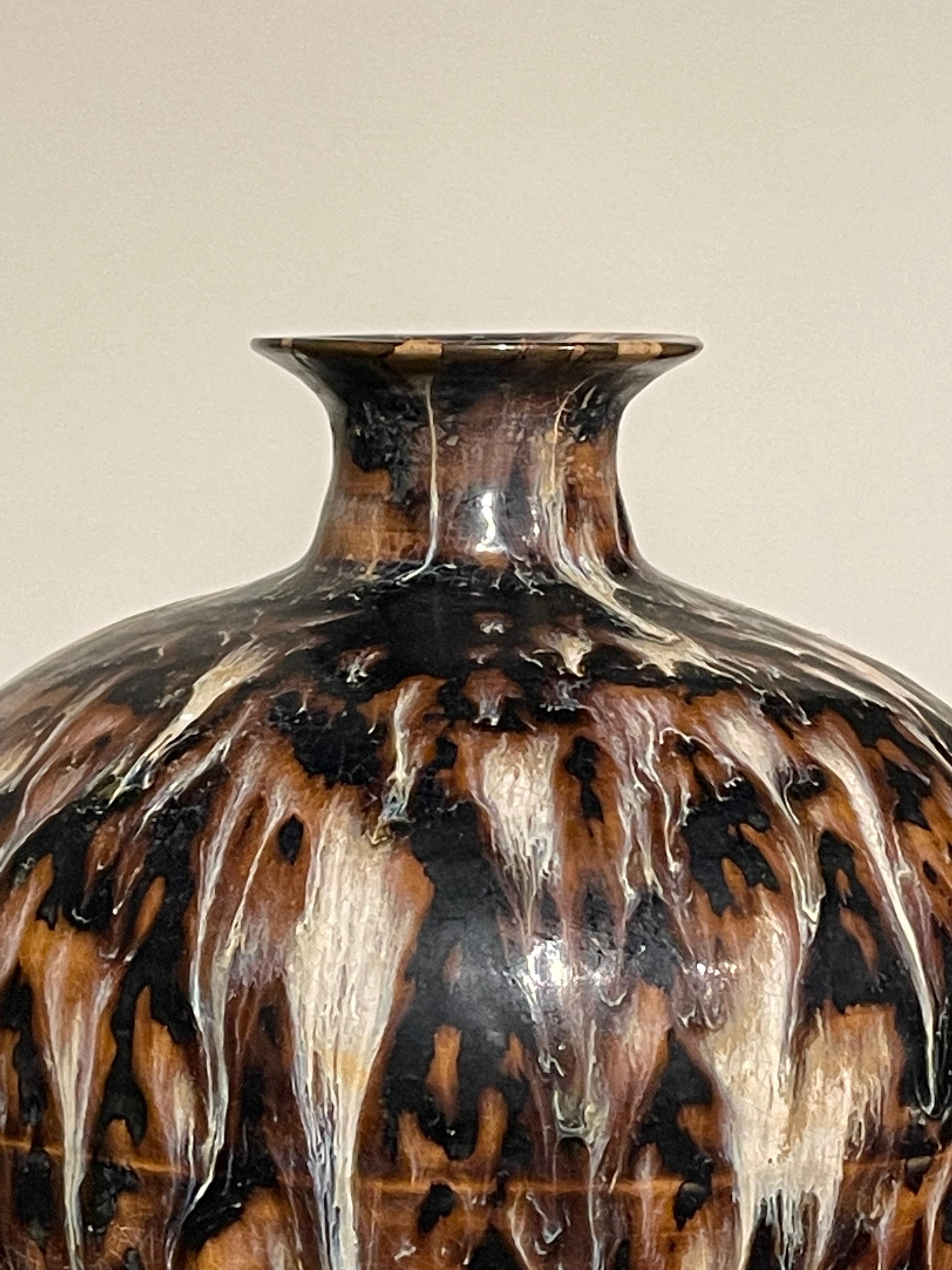 Contemporary Chinese squat shaped vase with tortoise effect glaze.
Black, brown and cream colors.
Two available and sold individually.
Also available in larger, taller style (S6311 )
