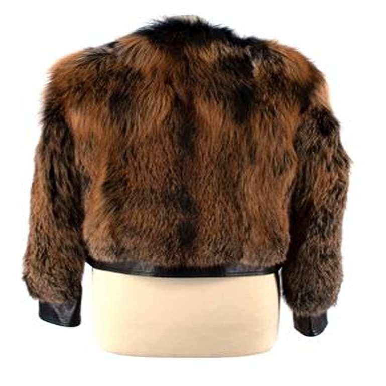 Prada Leather & Fox Fur Jacket
 

 - Black leather bomber jacket with dyed fox fur 
 - Partially leather sleeves and body
 - Orangey brown and black dyed fox fur 
 - Silver zip down the front 
 - Round neck with no collar 
 - Quilted satin lining 

