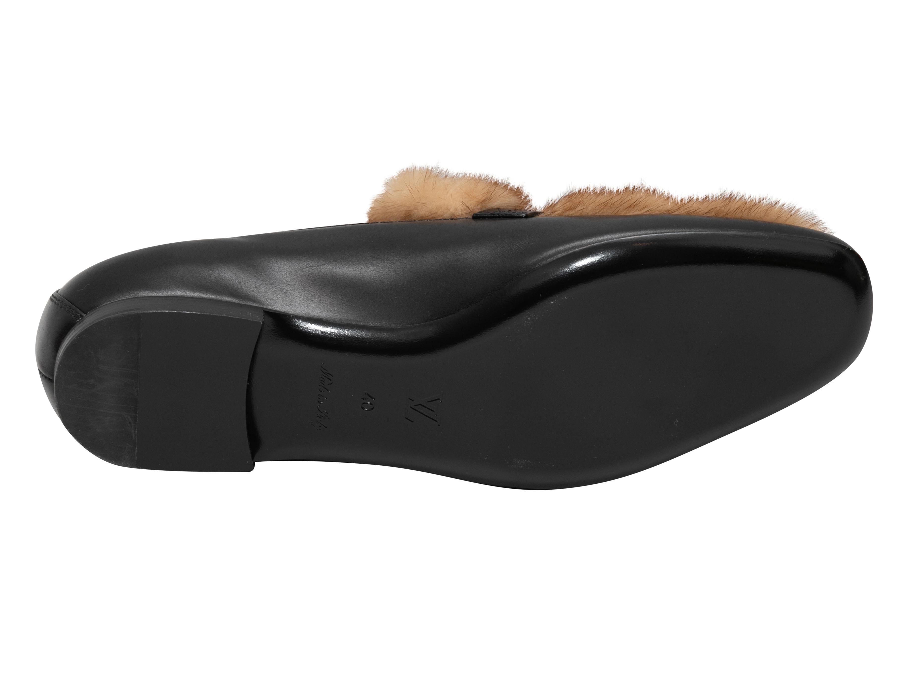 Black leather and brown mink fur loafers by Louis Vuitton. Gold-tone LV logo hardware at tops. Stacked heels 0.25
